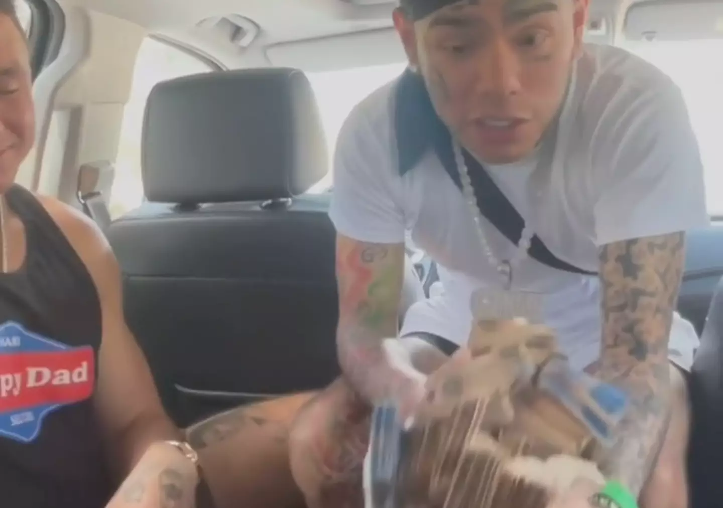 The rapper got out of the car on his way to the airport to hand $50,000 to a random family.