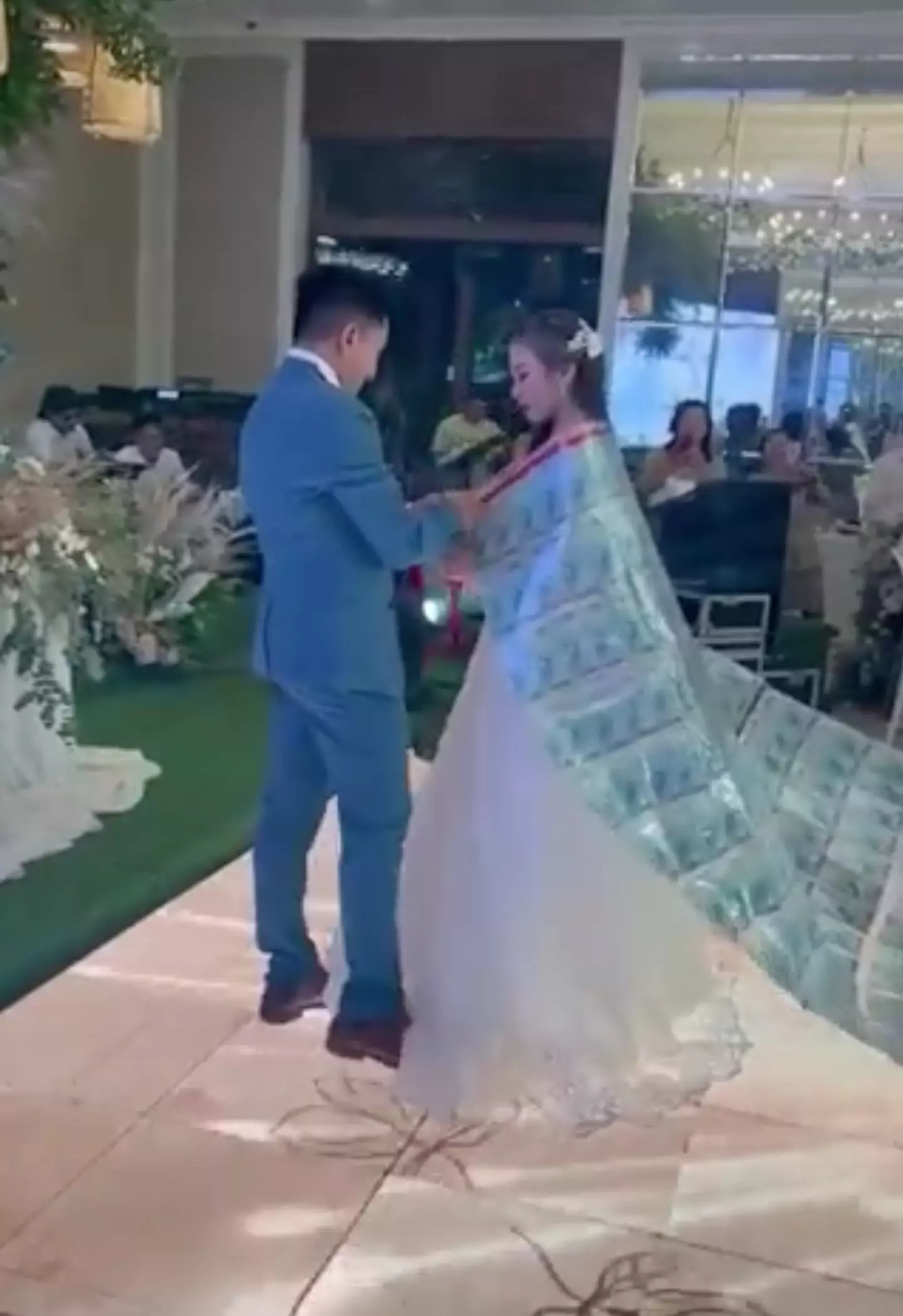 The bride wearing the cloak. (X / @PicturesFoIder)