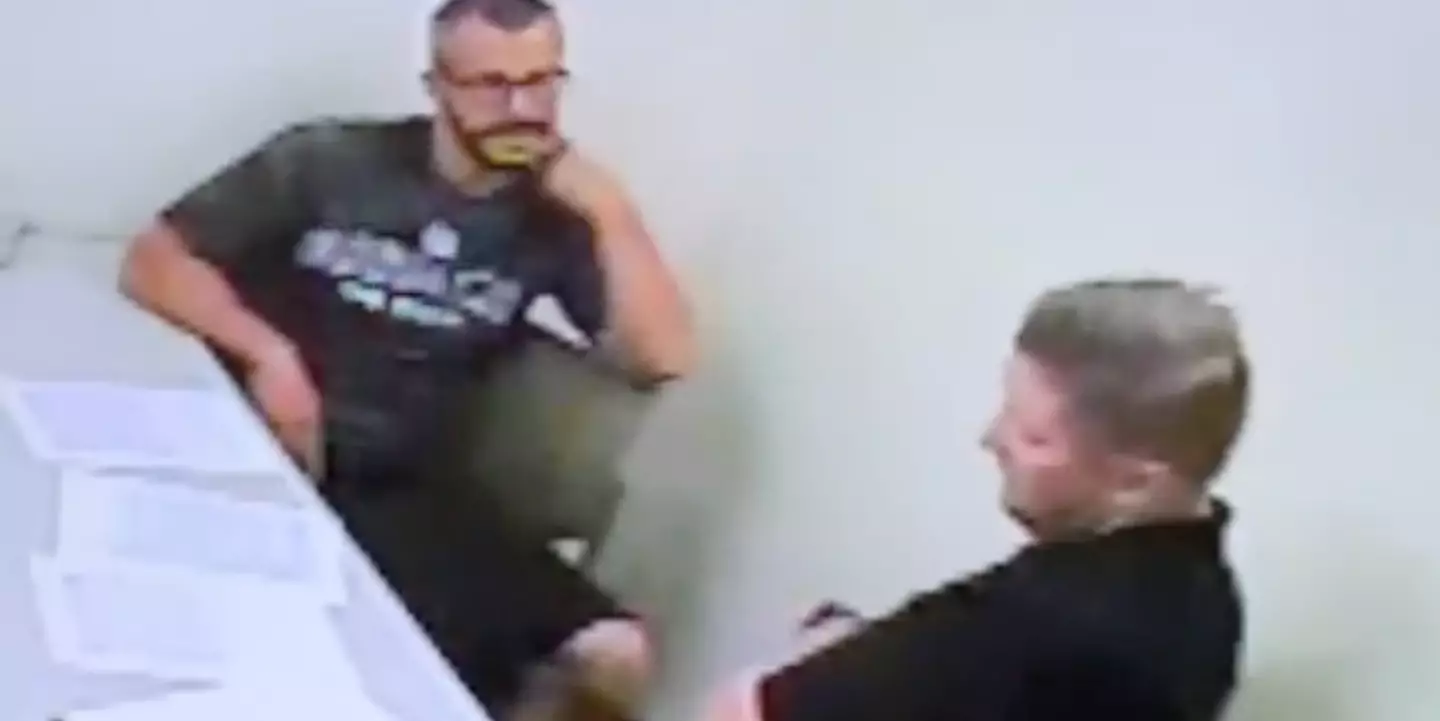 Chris Watts gesturing towards his neck.