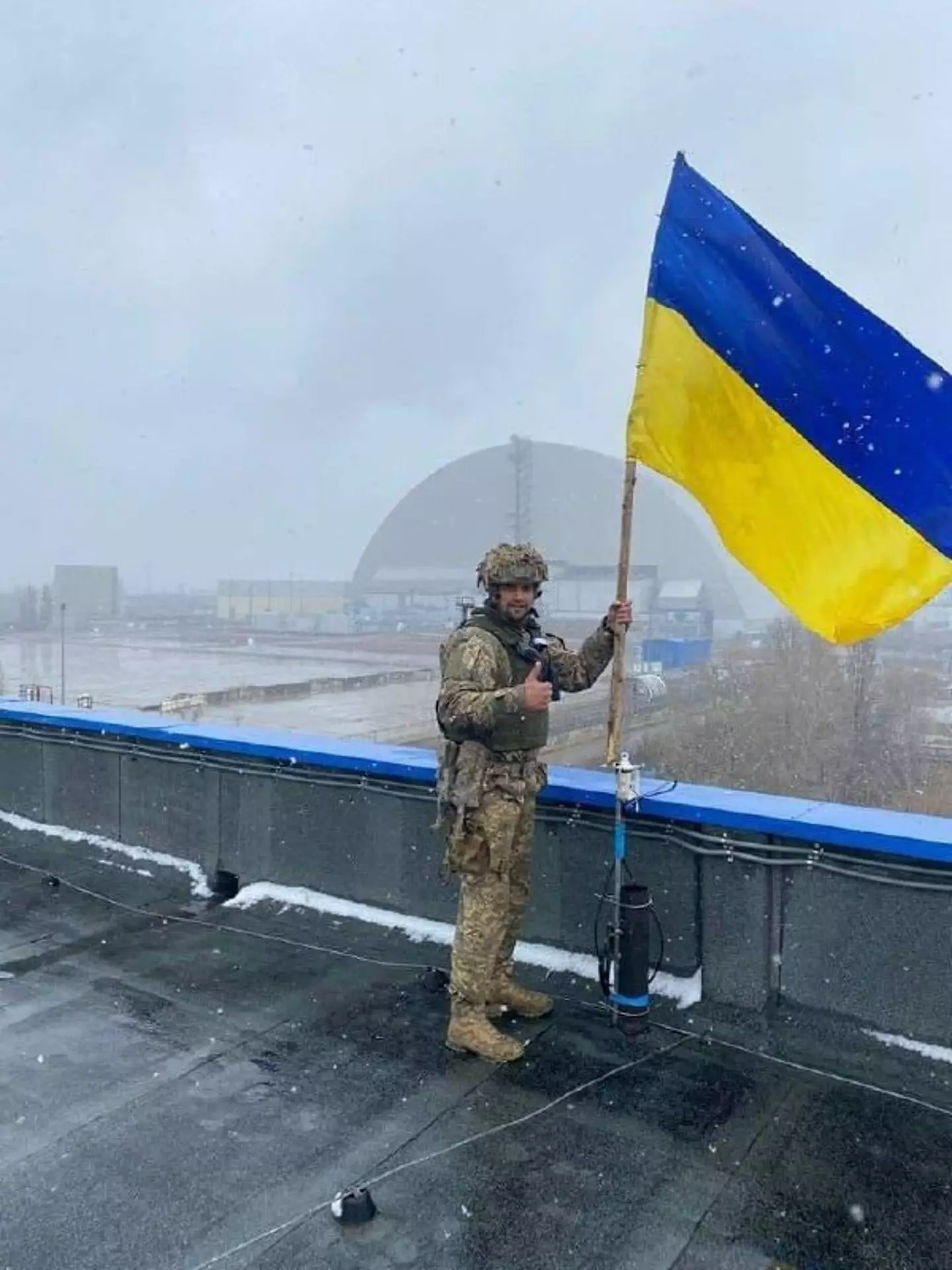 A Ukrainian soldier holding the flag at Chernobyl.