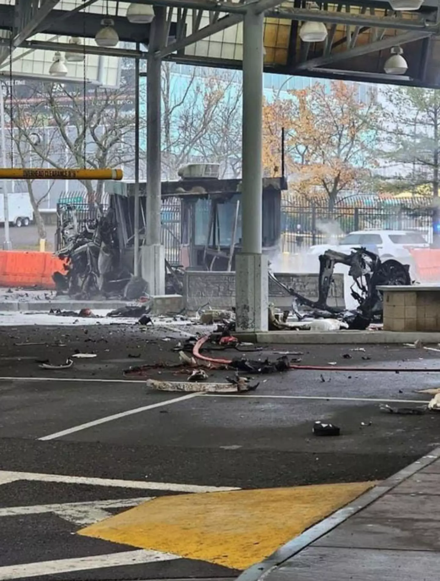 Photos of the scene show a fire and debris on the ground.