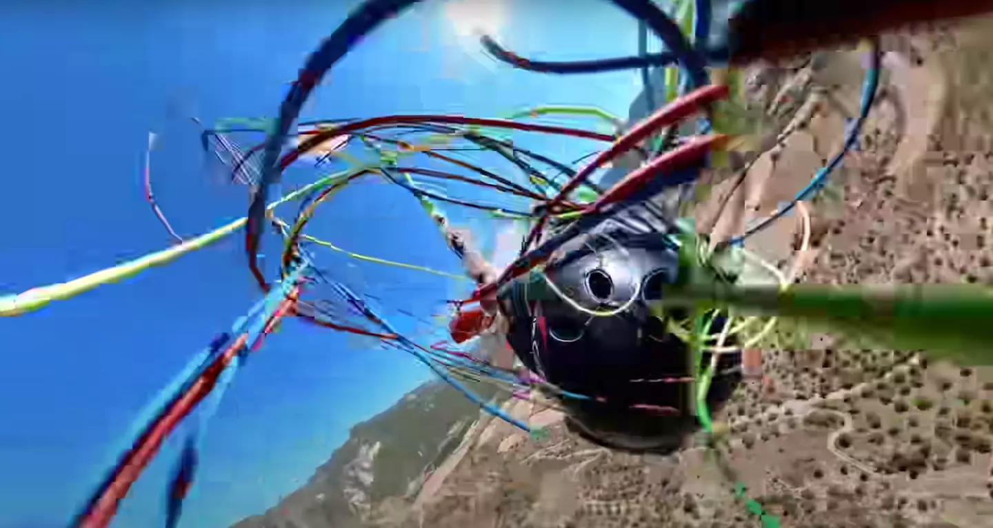 Kevin was performing the adventure sport 'acro paragliding' mid-air.