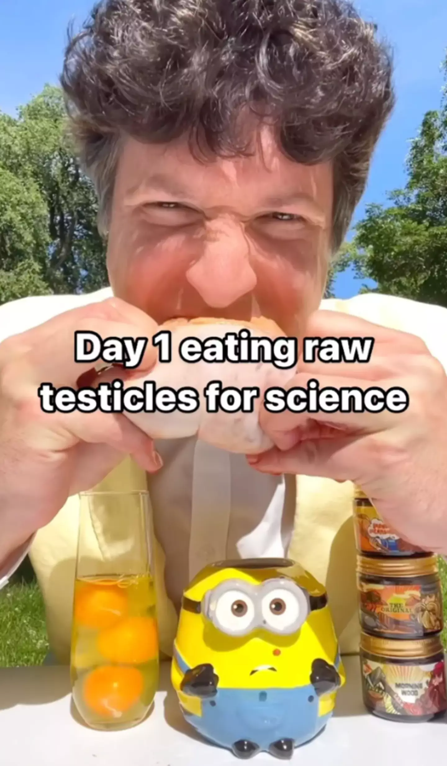 The internet has been left horrified after watching John chomp down on raw bull testicles. (Instagram/@rawmeatexperiment)