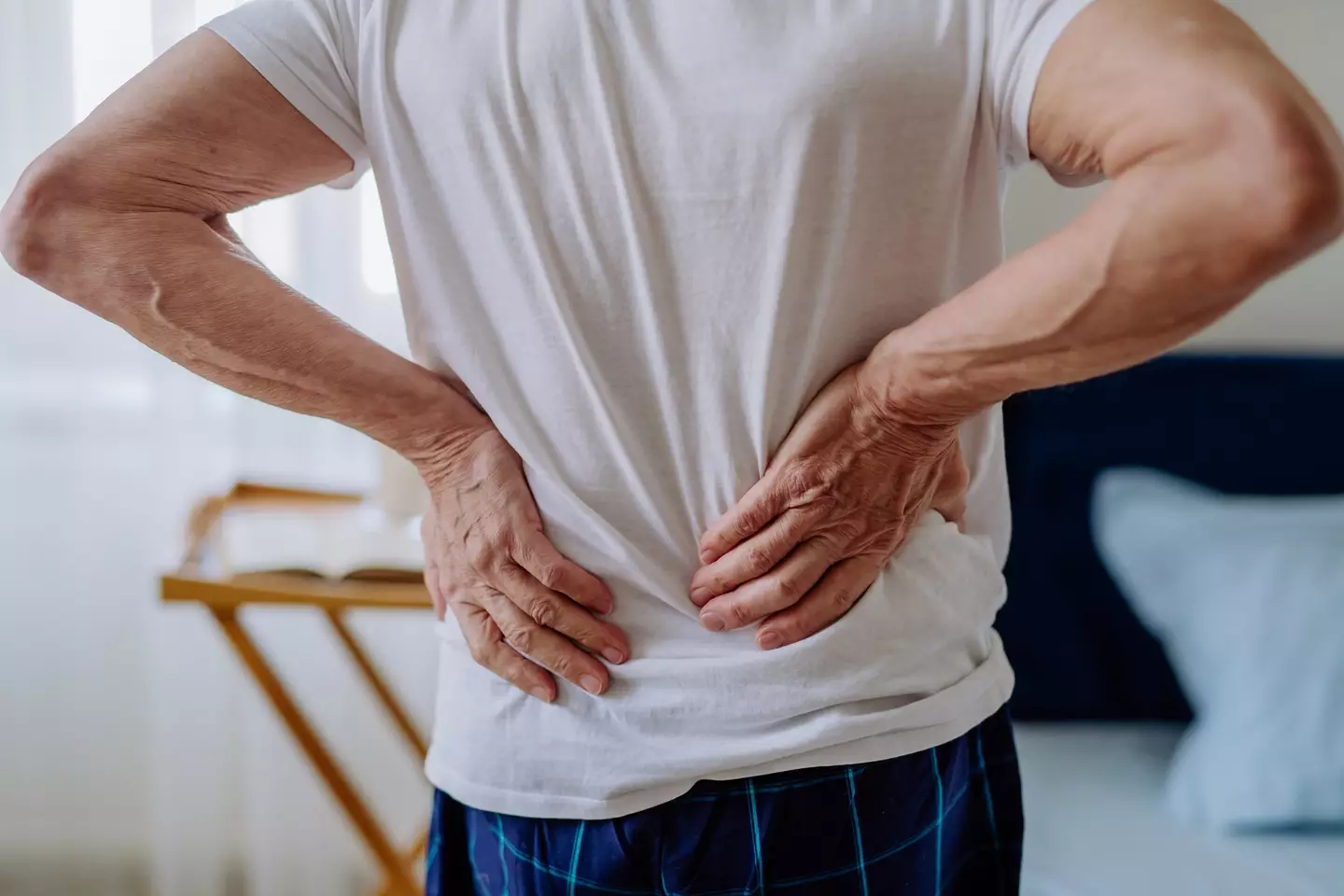 Back pain can also be a warning sign (Halfpoint Images/Getty Images)