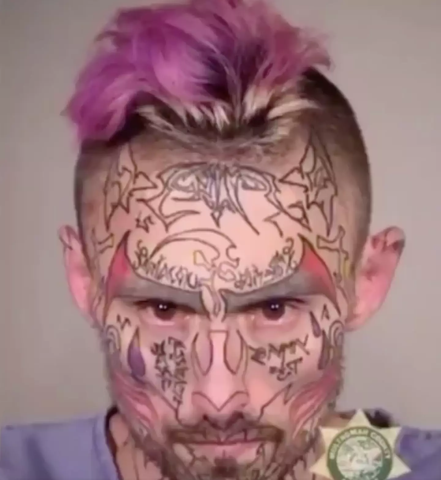 In his final mugshot he has a barrage of face tattoos.