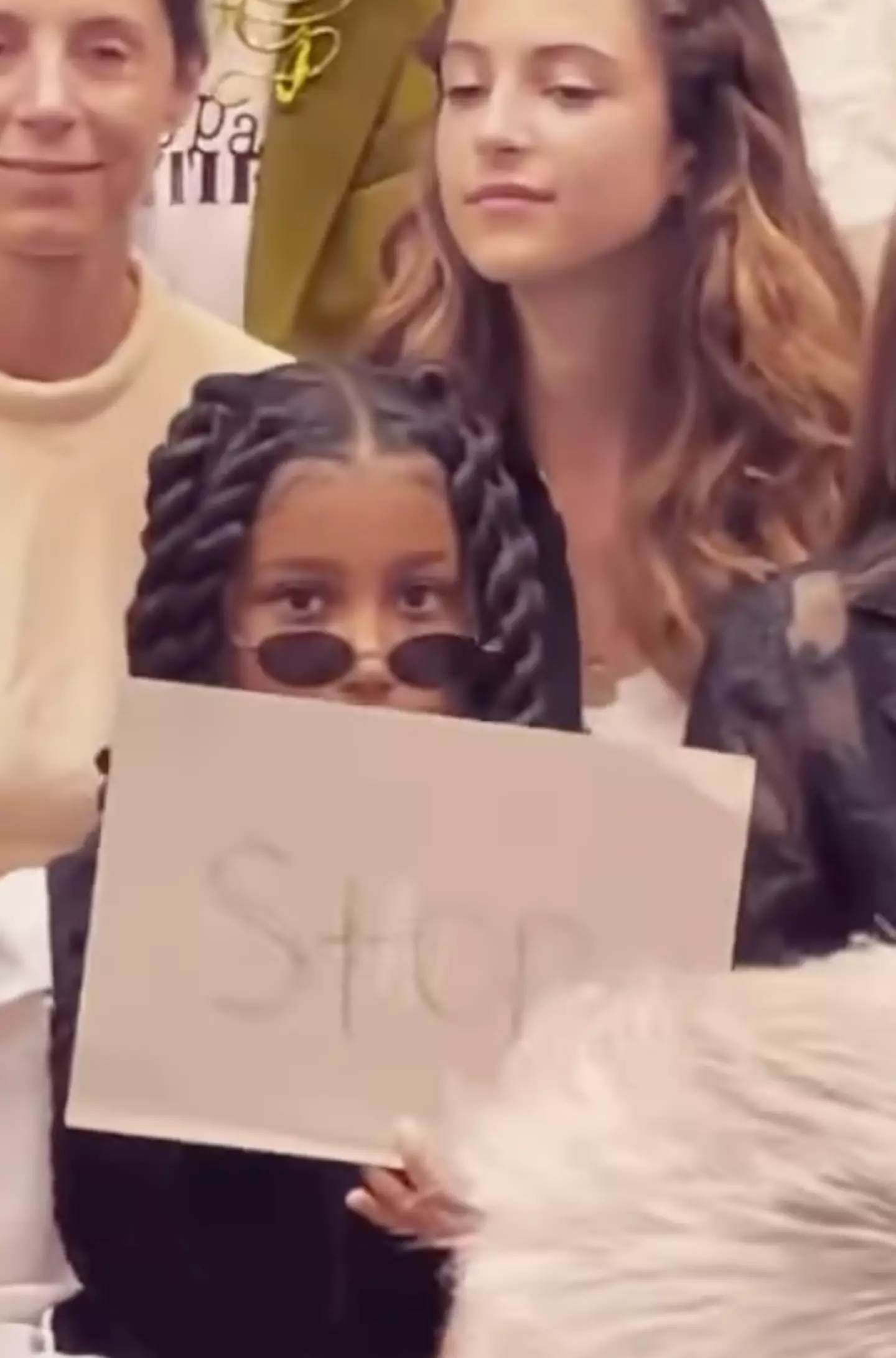 North held up a sign that read ‘stop’ at the Jean Paul Gaultier Haute Couture show.