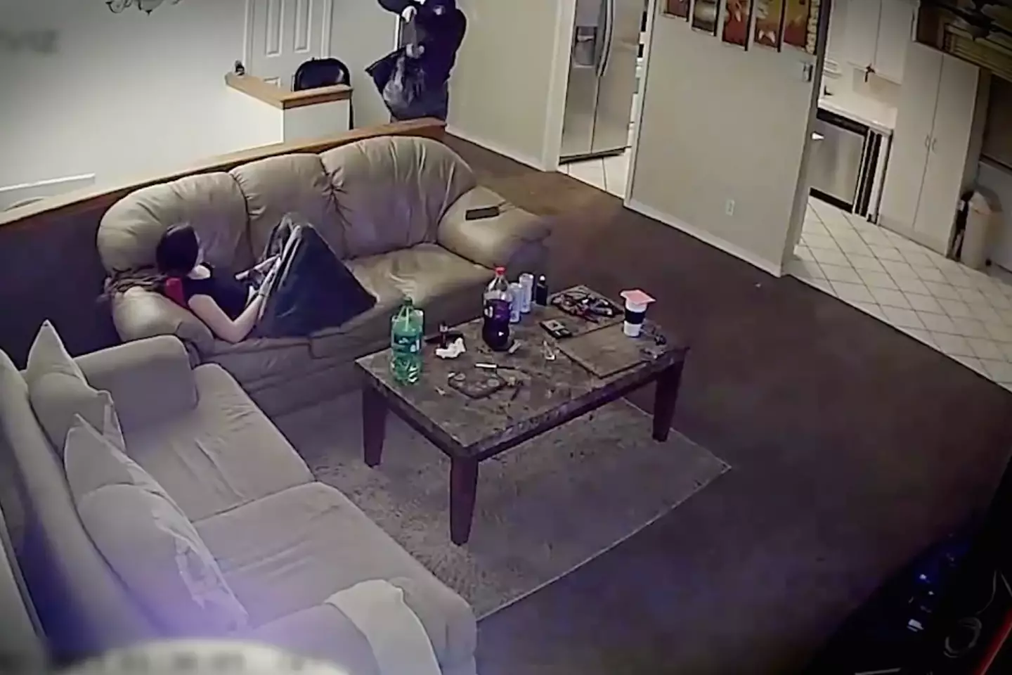 The gunman points his weapon towards Isabelle after reaching the top of the stairs causing her life to flash before her eyes.