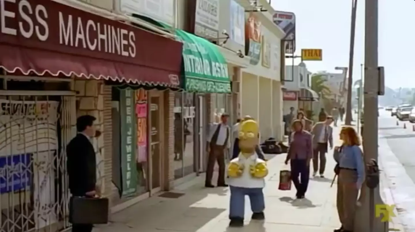 A nervous Homer walks down the street.