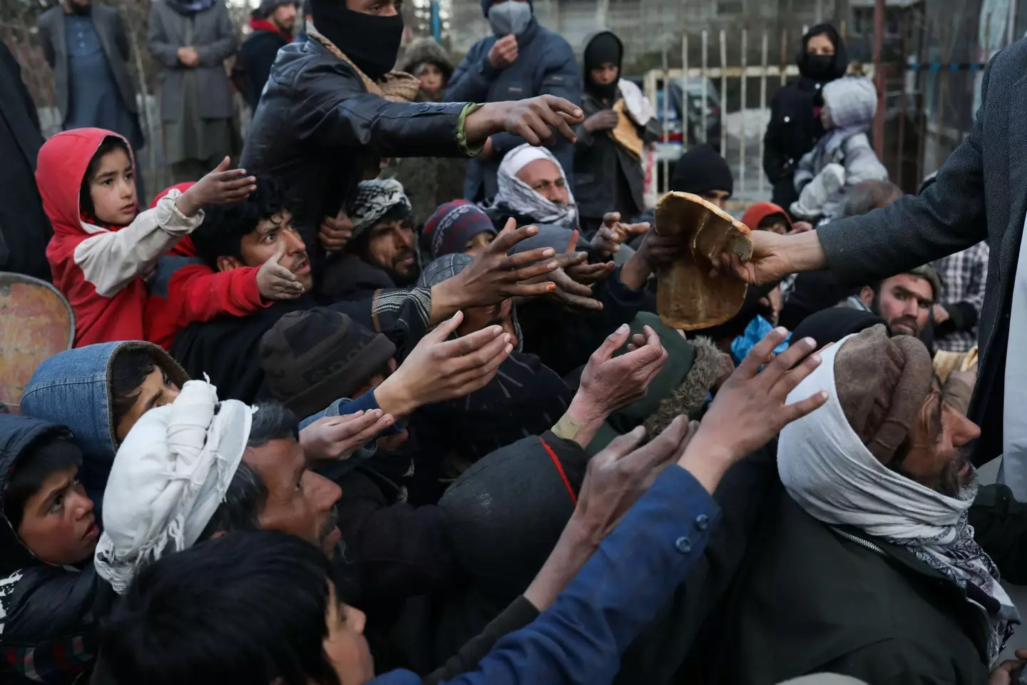 Afghan citizens waiting to receive bread (Alamy)