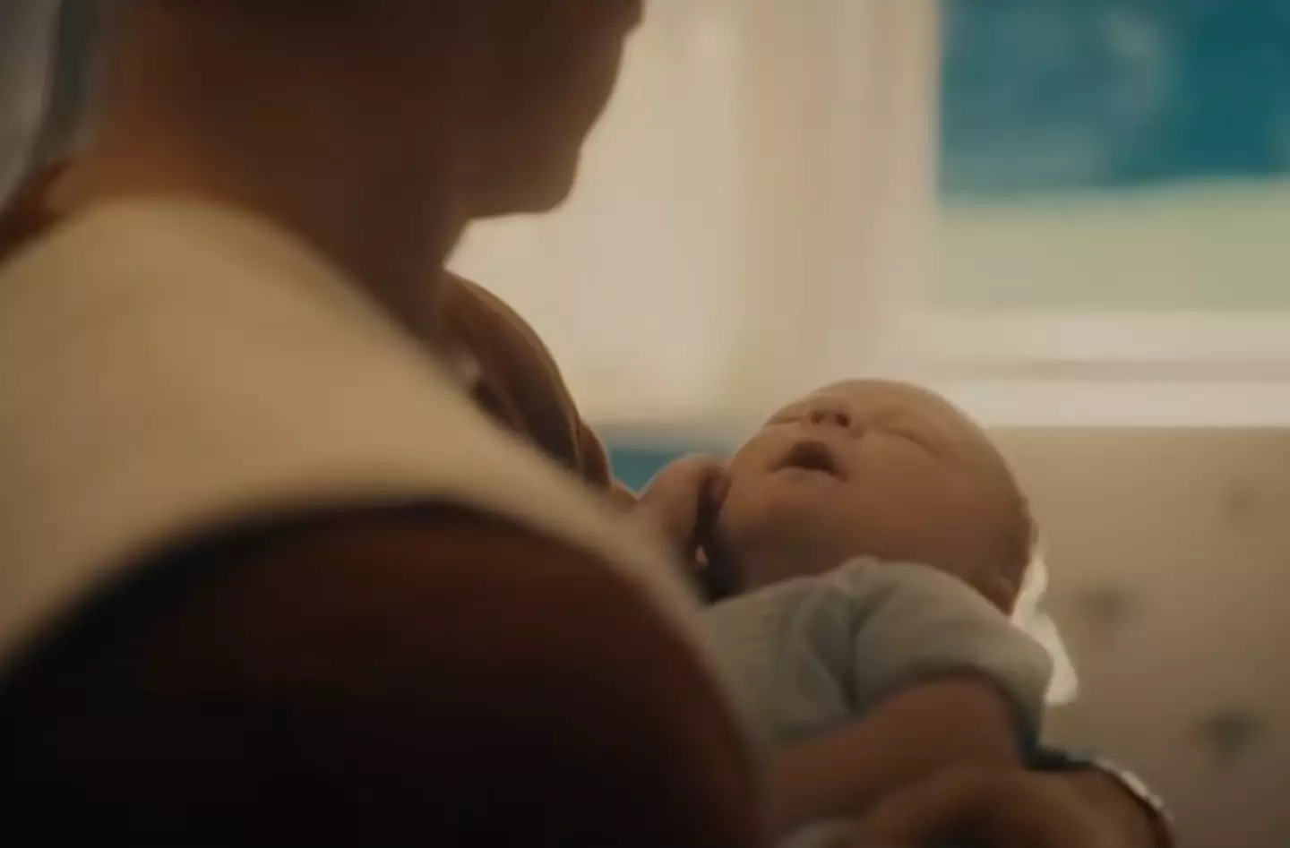 Rodgers is seen smiling as he holds a newborn baby (Marvel)