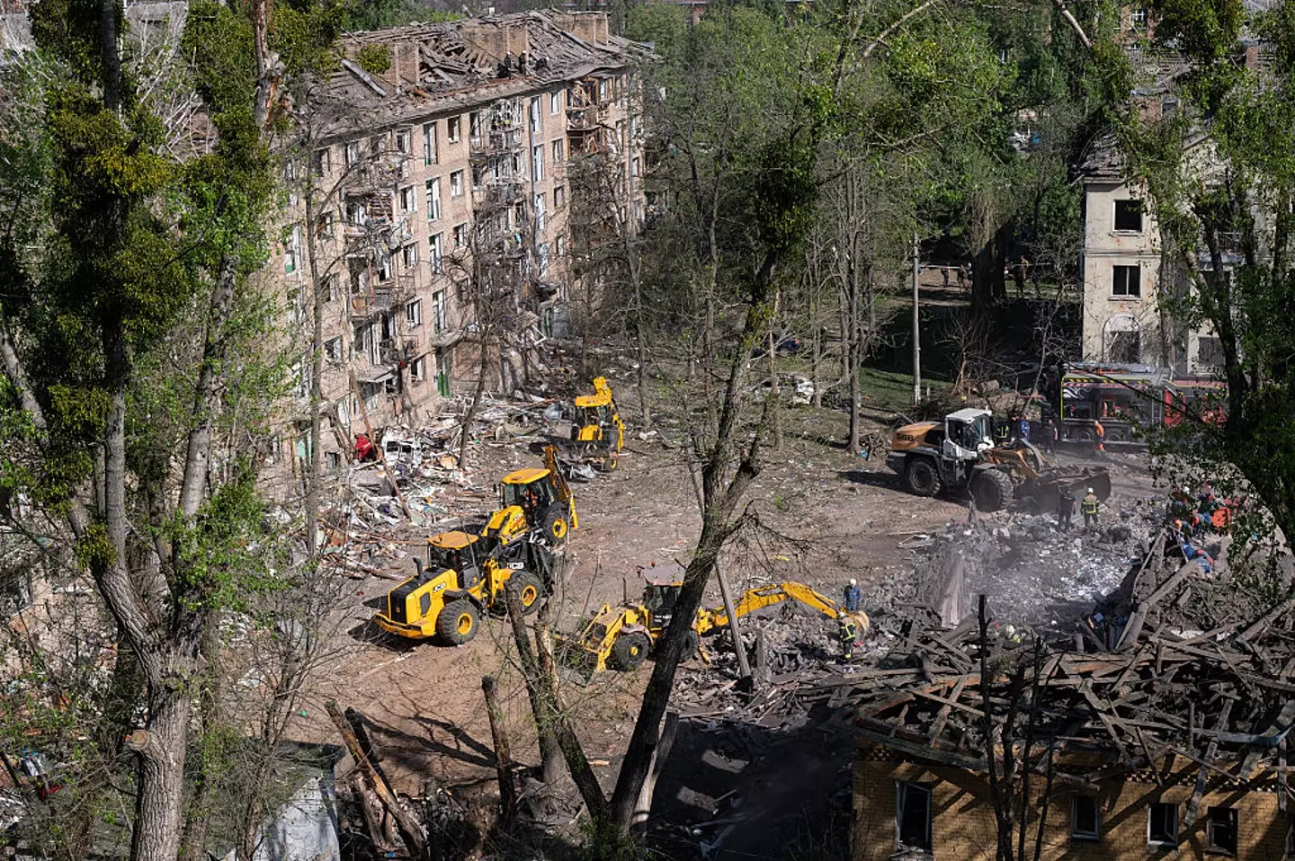 Residents pictured cleaning up the aftermath of the Russian missile attack on Kyiv, Ukraine, on April 24 (Danylo Antoniuk/Anadolu via Getty Images)