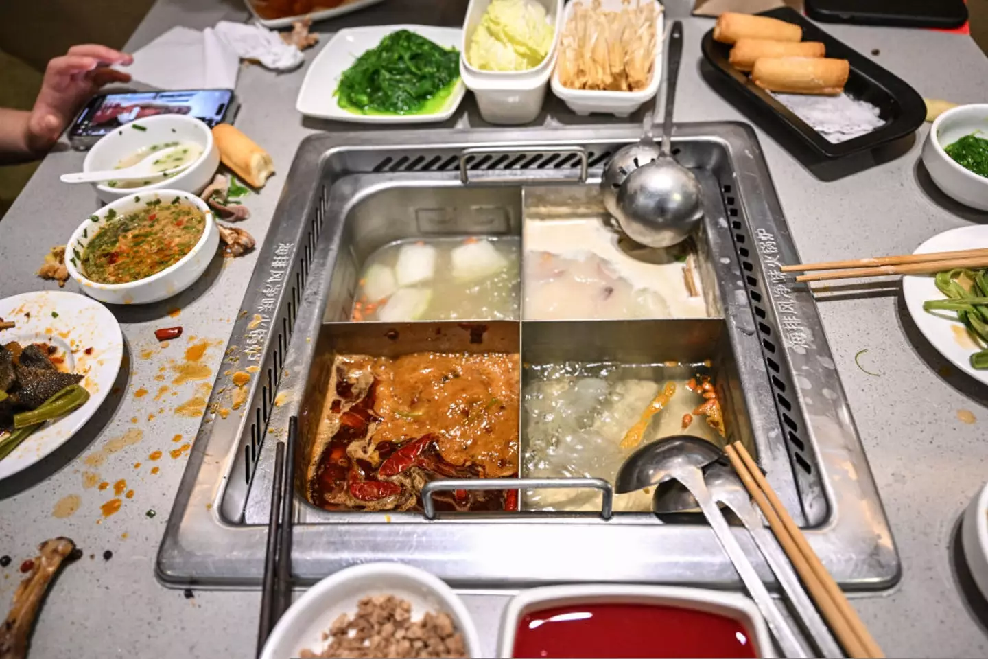 The teens peed into a broth pot in a Haidilao restaurant (JADE GAO/AFP via Getty Images)