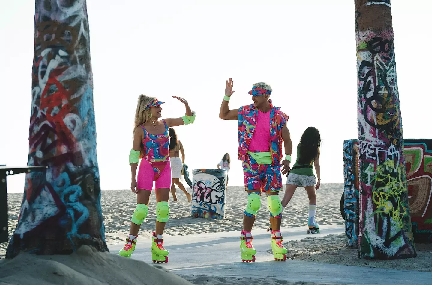 Margot Robbie and Ryan Gosling donning their roller skates.