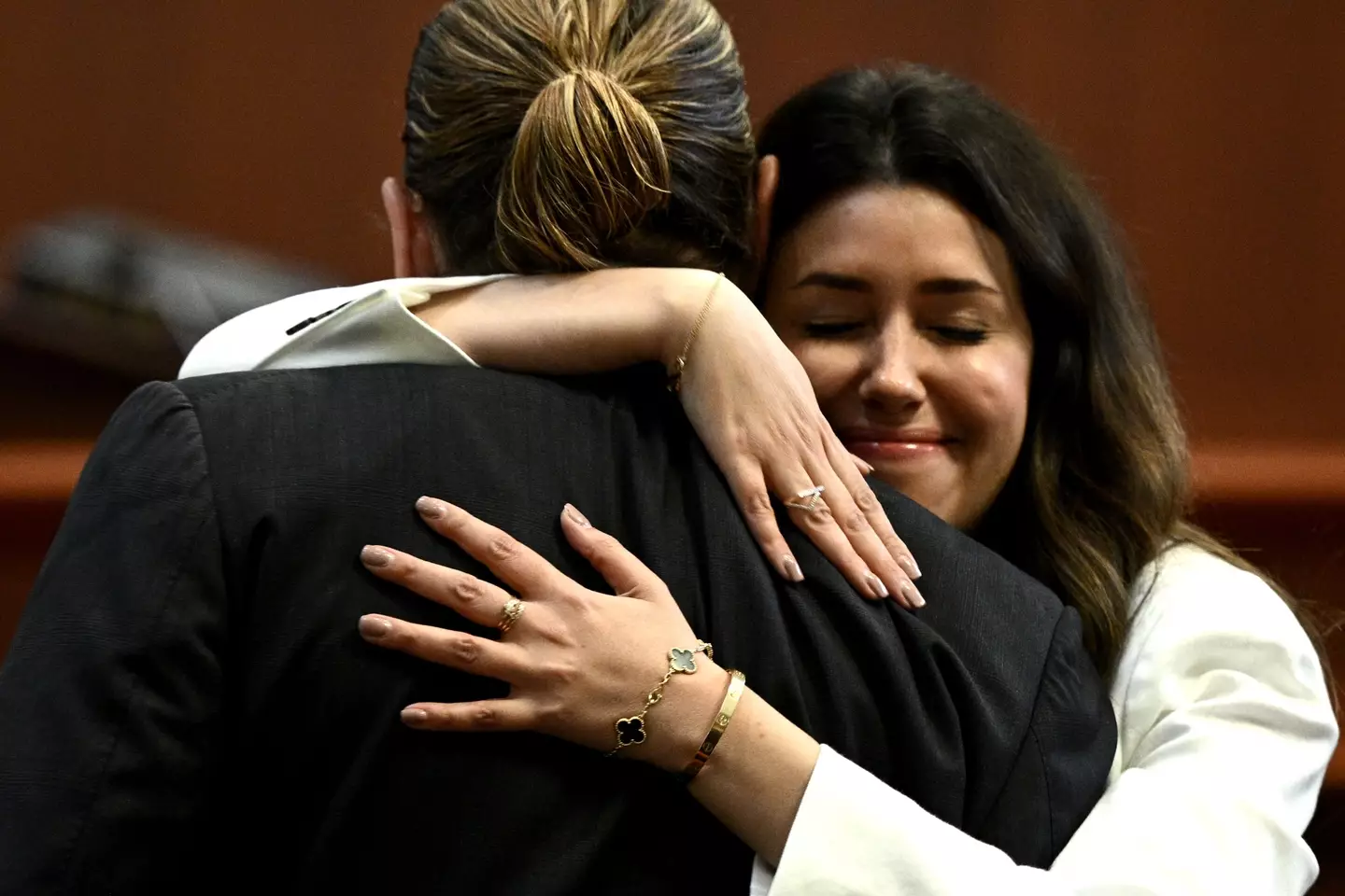Camille Vasquez hugging Johnny Depp in the courtroom.