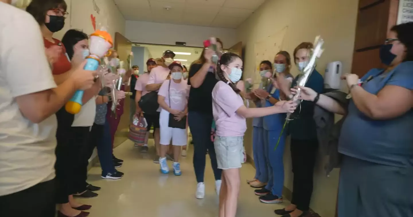 10-year-old Mayah Zamora handed out roses to hospital staff as she left.
