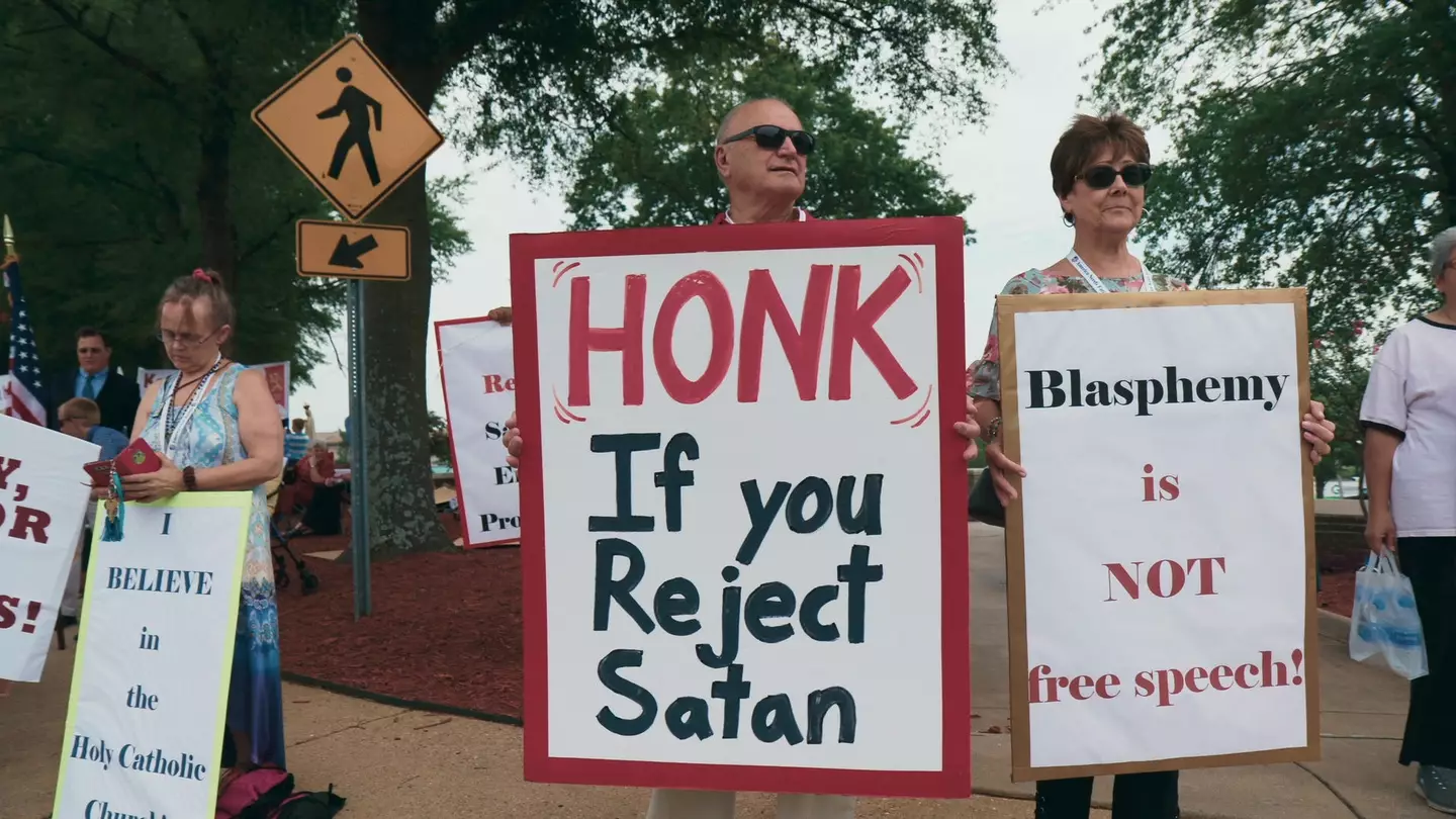 Protesters holding signs against The Satanic Temple in Little Rock, Arkansas in 2019.