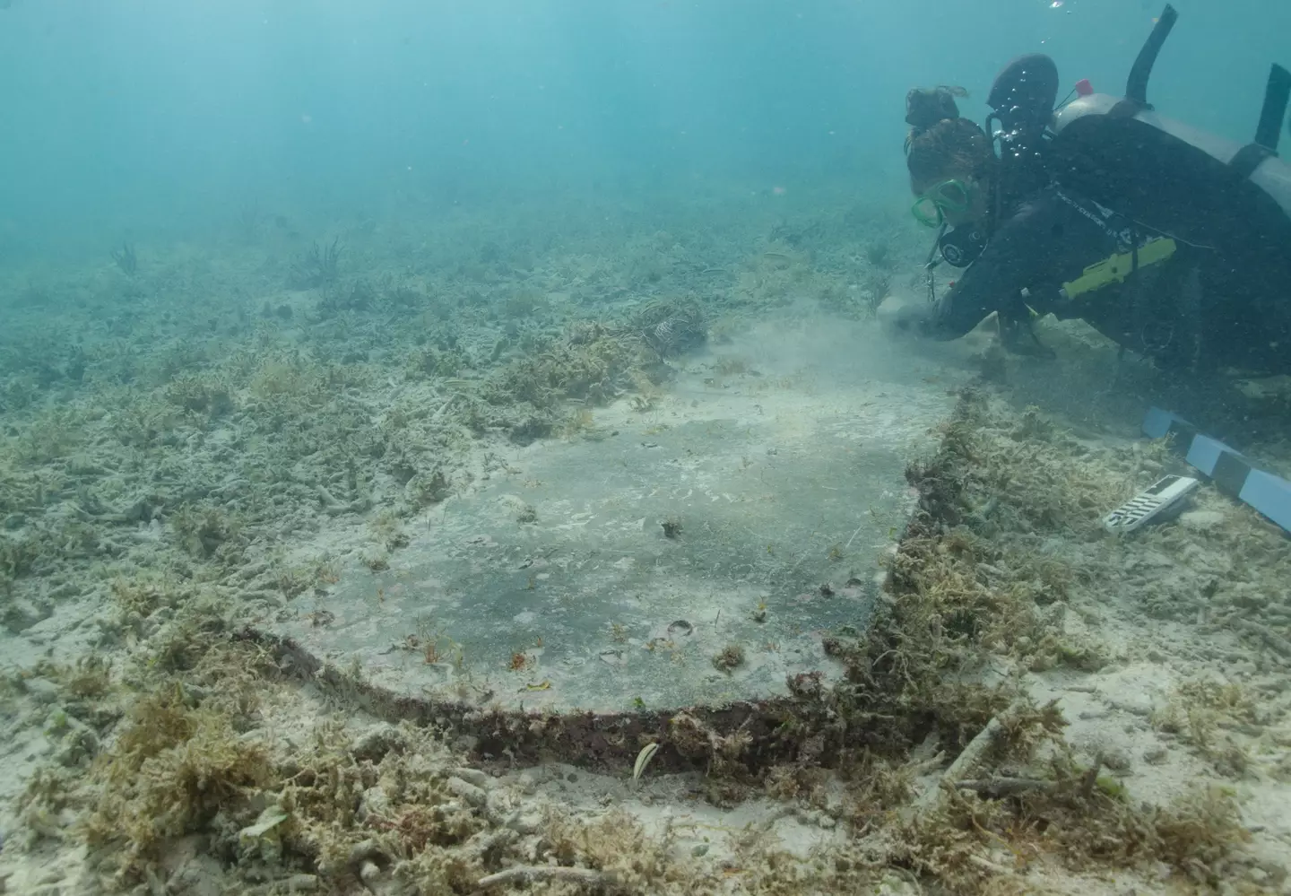 Divers found a large tombstone at the archeological site.