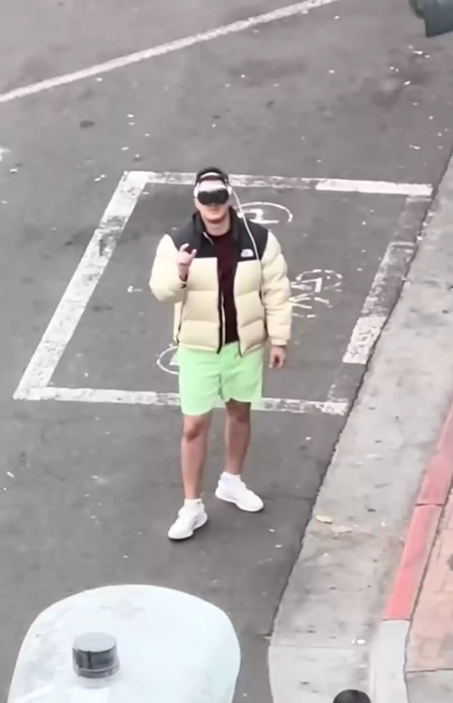 The man is seen minding his own business while wearing Apple Vision Pros.