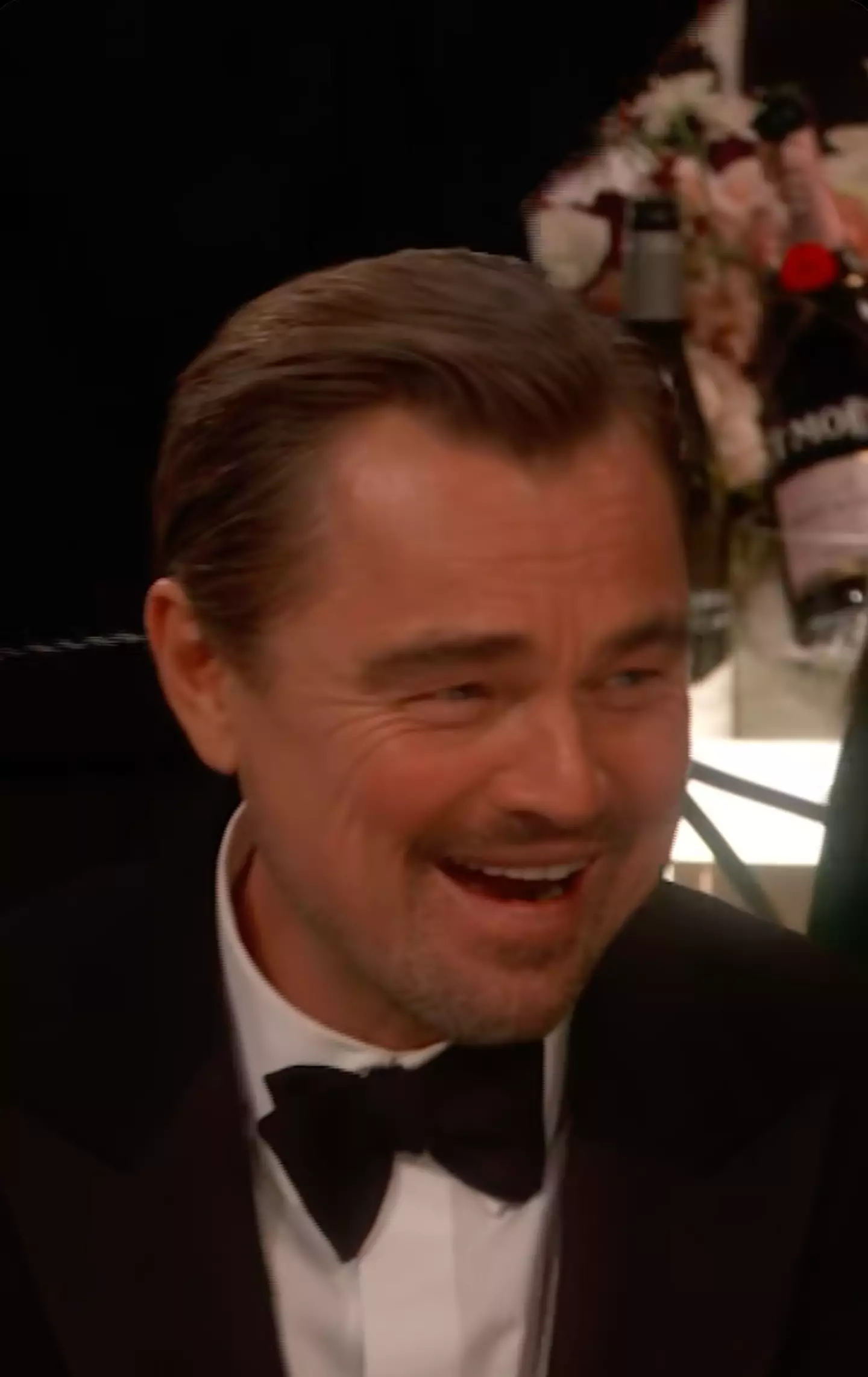 DiCaprio laughed as he mouthed and gesticulated at someone (Golden Globes)
