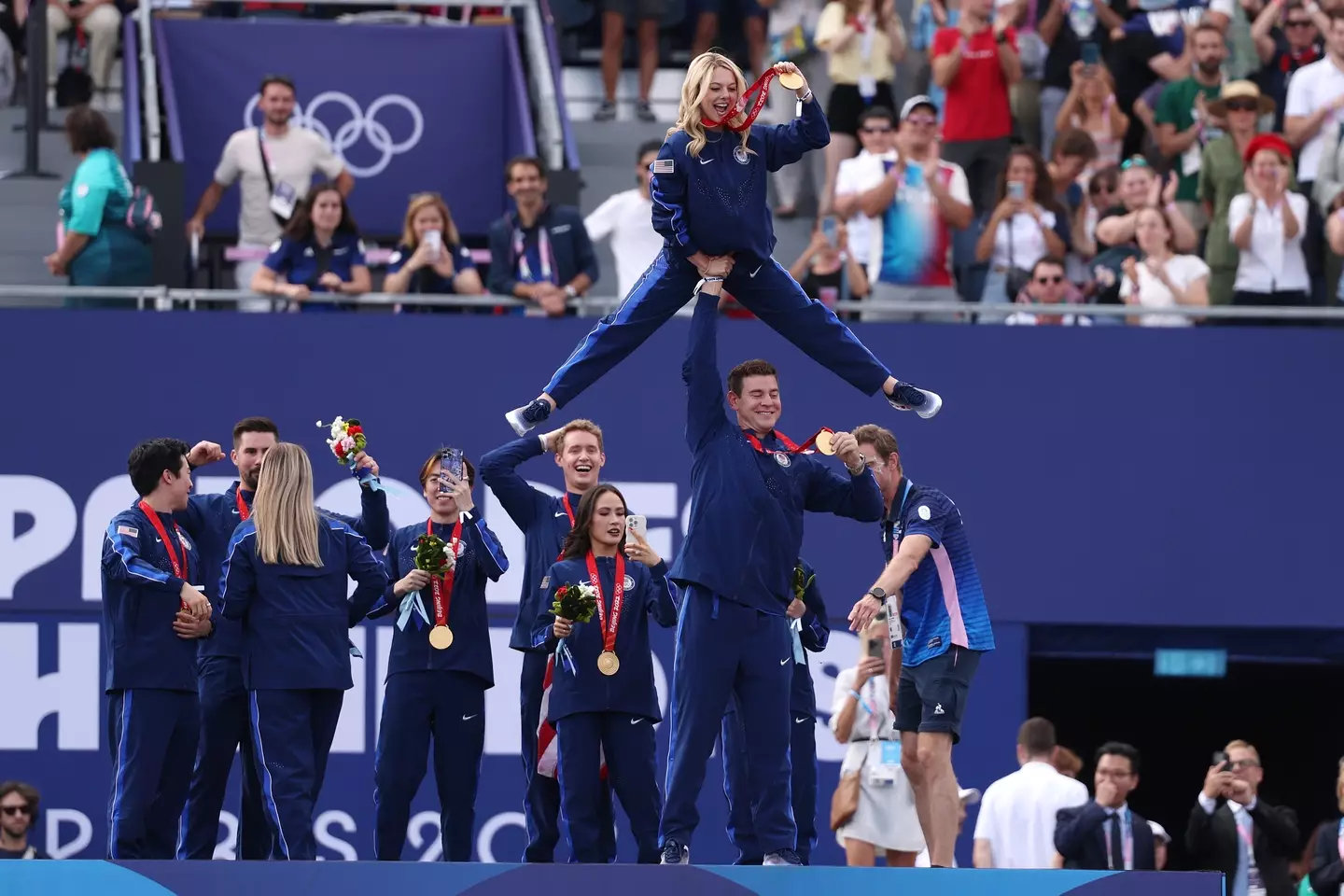 The team celebrate finally receiving their medals. (Michael Reaves/Getty Images)
