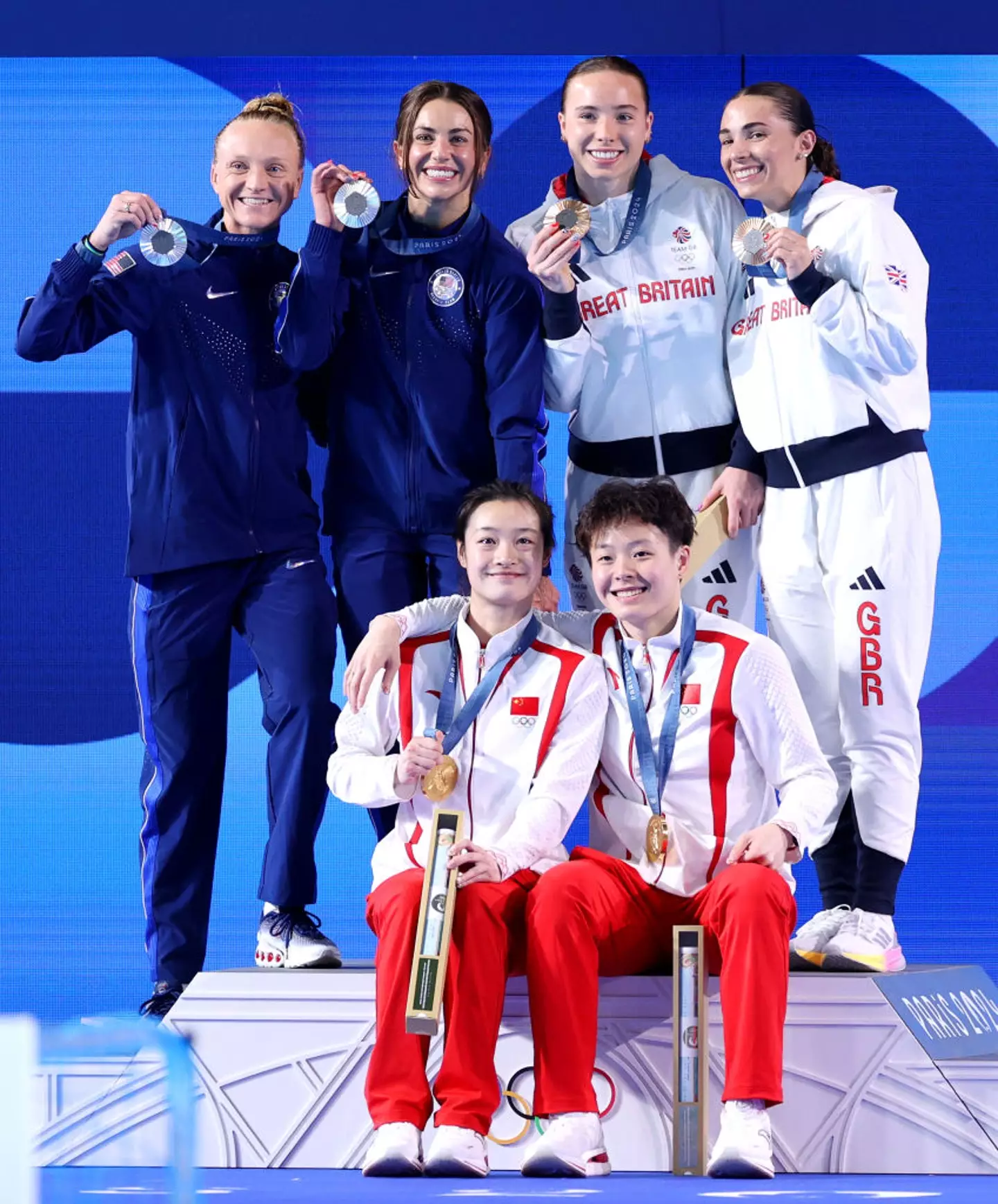 Silver medalists Sarah Bacon and Kassidy Cook of Team USA got into a slightly awkward moment with Chinese gold medallists Yani Chang and Yiwen Chen, moments before this shot. (Sarah Stier/Getty Images)