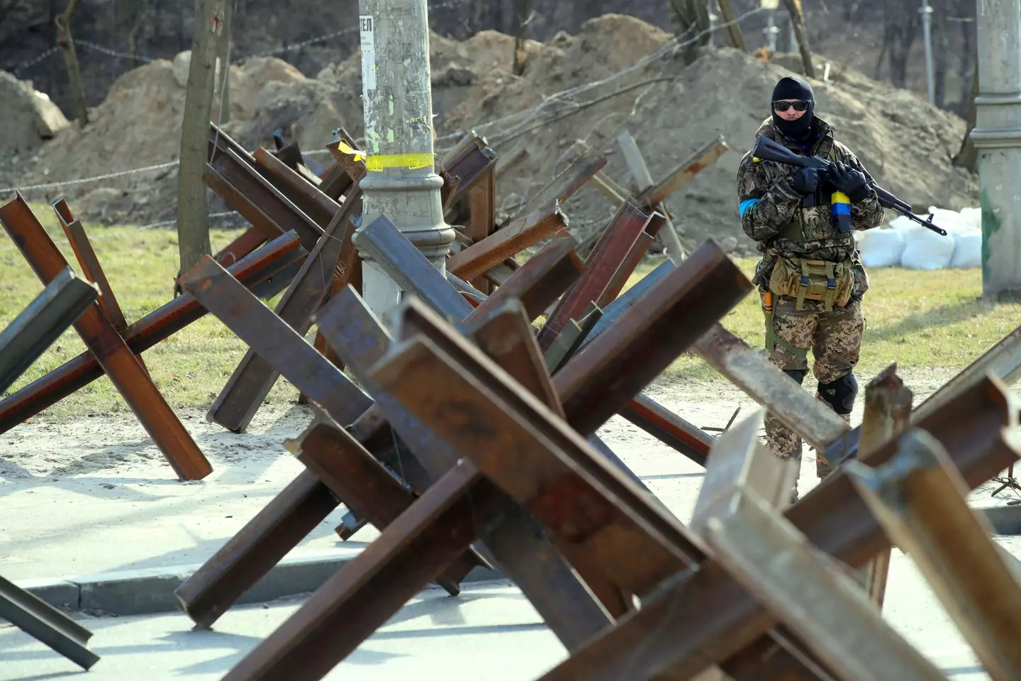 An armed Territorial Defence soldier stands guard at a roadblock, Kyiv, capital of Ukraine.