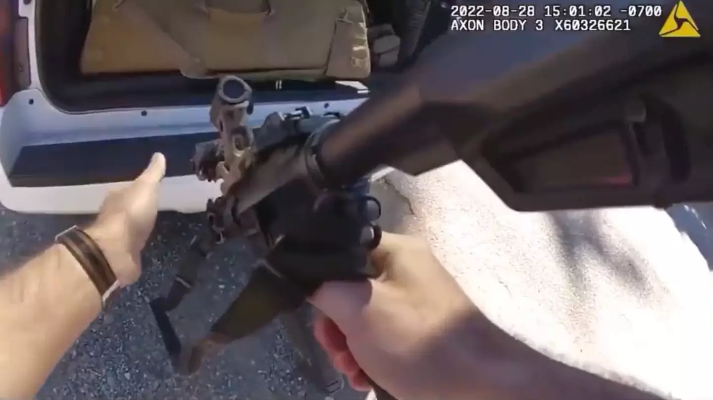 The officer retrieved an assault rifle from the trunk.