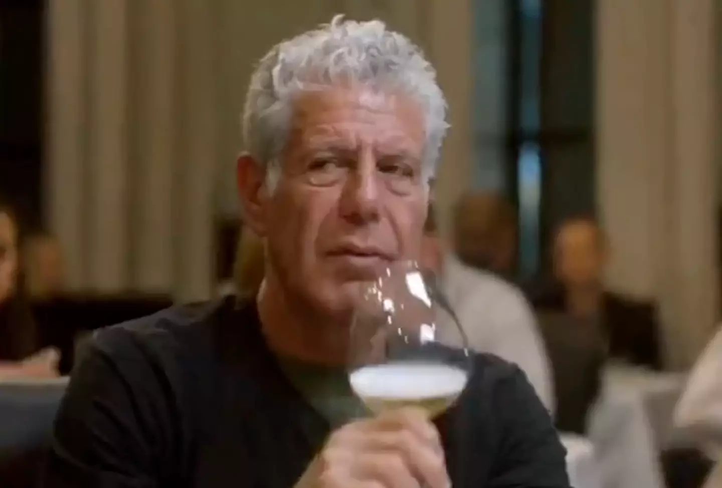 Anthony Bourdain's reaction to the toasting of the Queen has gone viral online.
