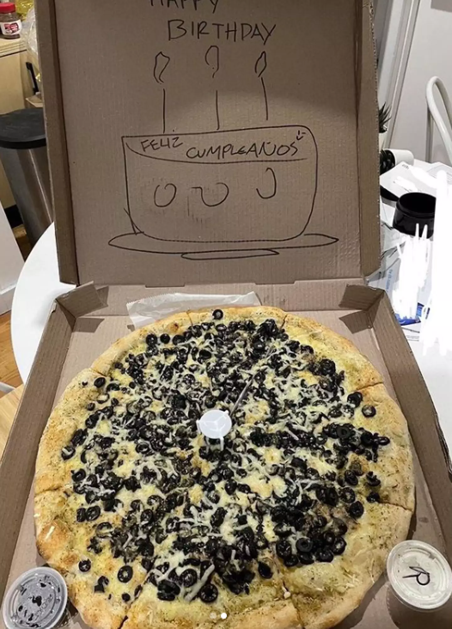 The pizza was topped with a crazy amount of olives.
