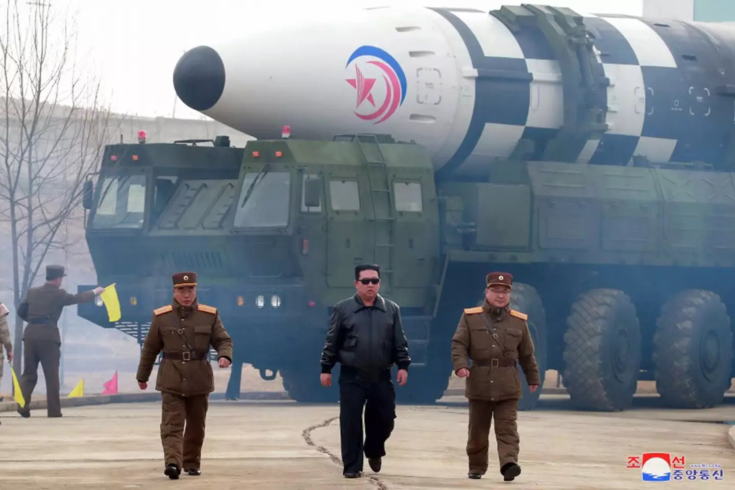 North Korean leader Kim Jong-un next to missiles,