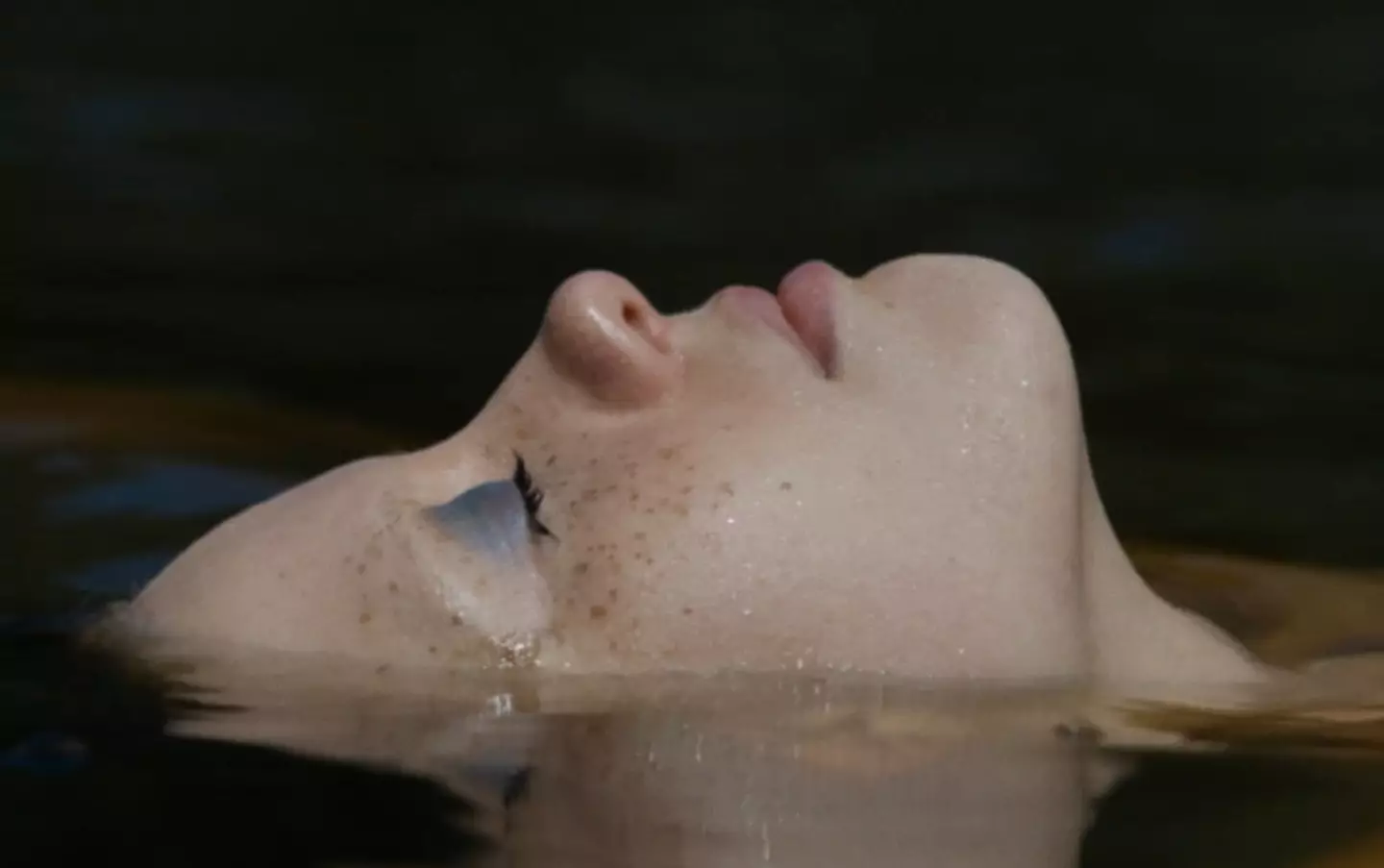 The scene sees Mia Goth floating in a lake.