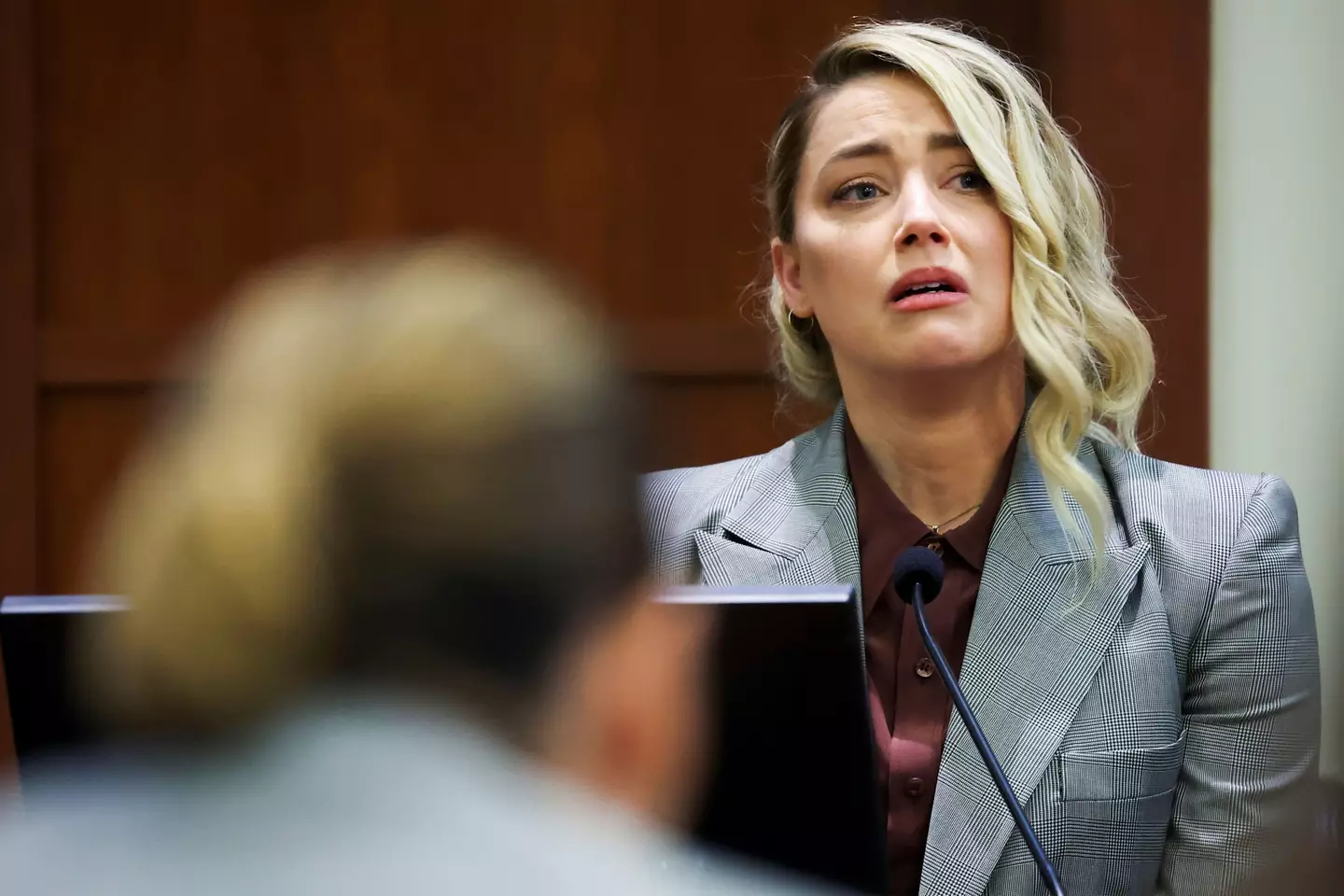 Actor Amber Heard testifies near Actor Johnny Depp.