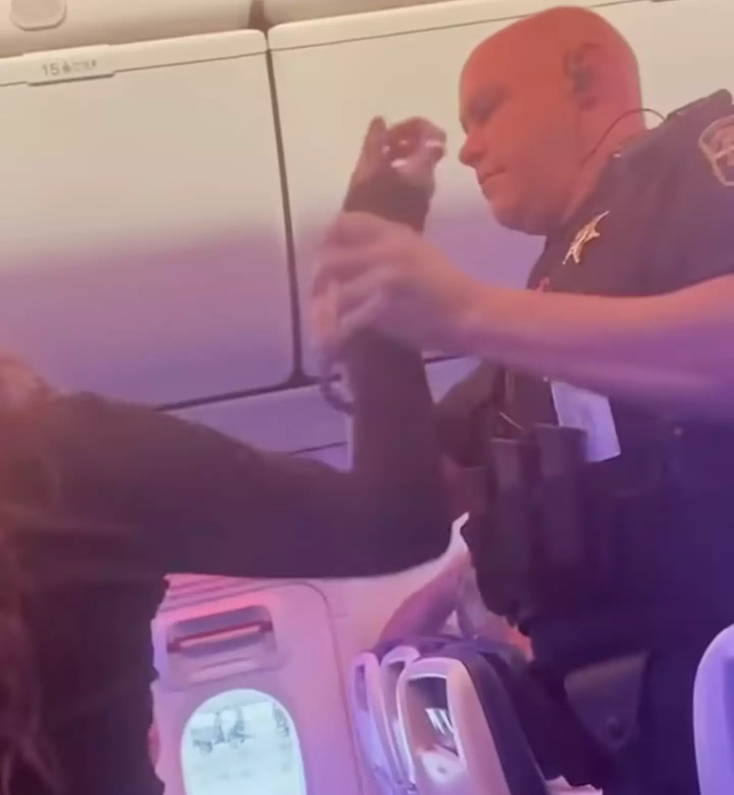 The woman was removed from the plane by law enforcement officers.