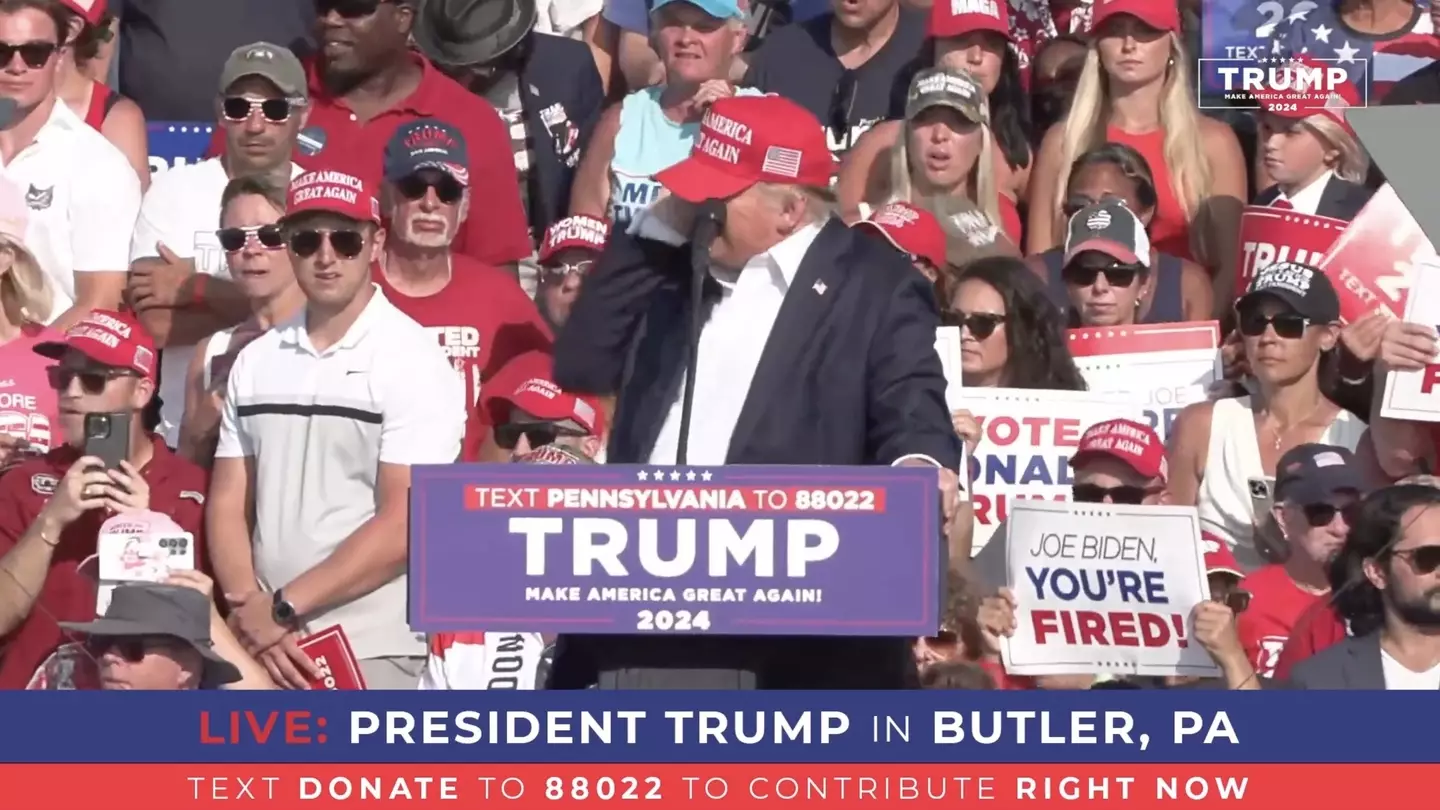 Trump's hand flew to the right hand side of his face (Trump Campaign Office / Handout/Anadolu via Getty Images)