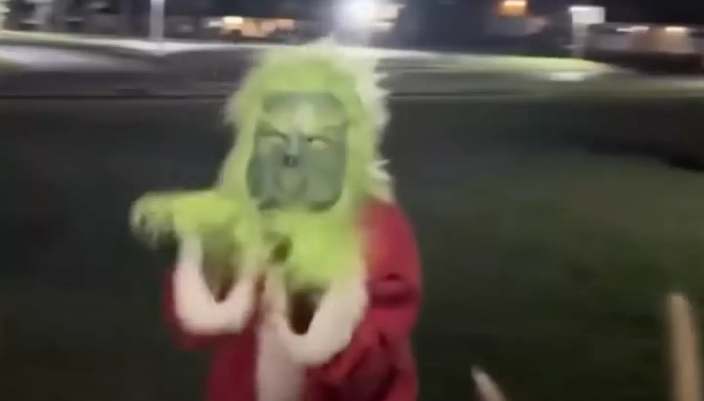 The Grinch mocked the woman being led away by police. Credit:Fox35