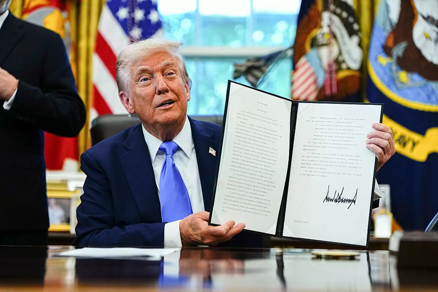 President Donald Trump signs a proclamation that would move to extensively overhaul the H-1B visa program (Aaron Schwartz/CNP/Bloomberg via Getty Images)