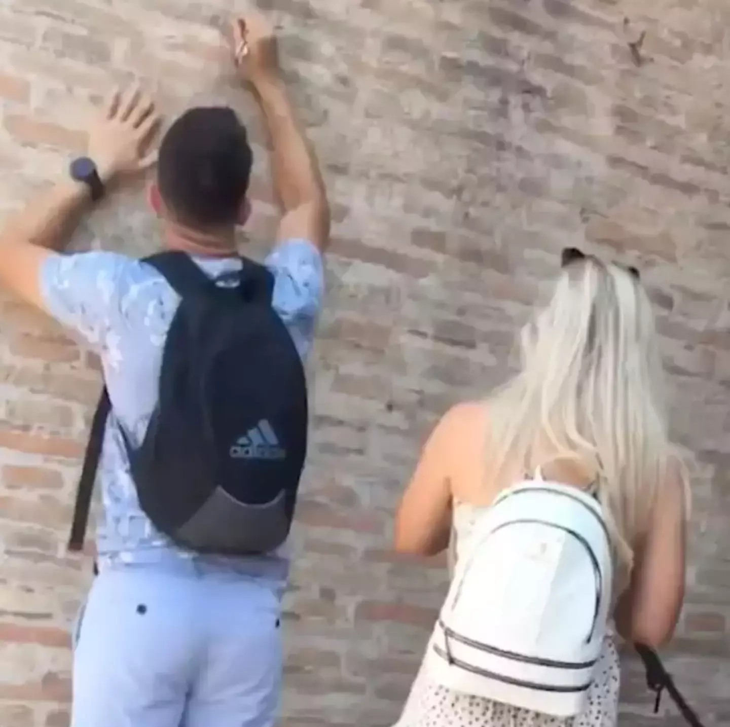 The man was seen defacing the Colosseum.