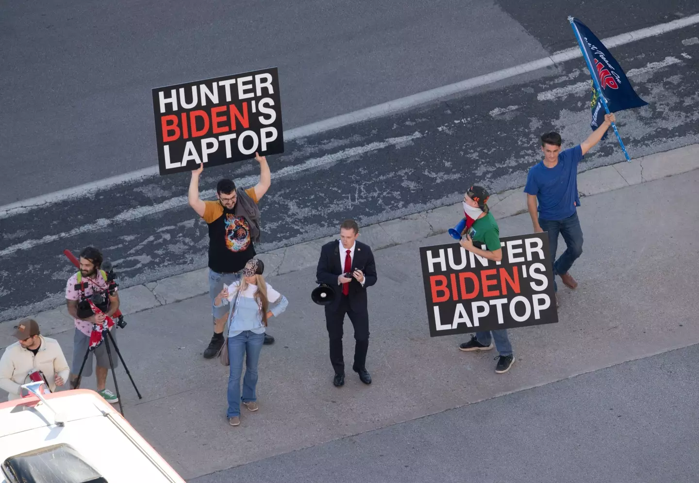Trump supporters with 'Hunter Biden laptop' signs. (Alamy)