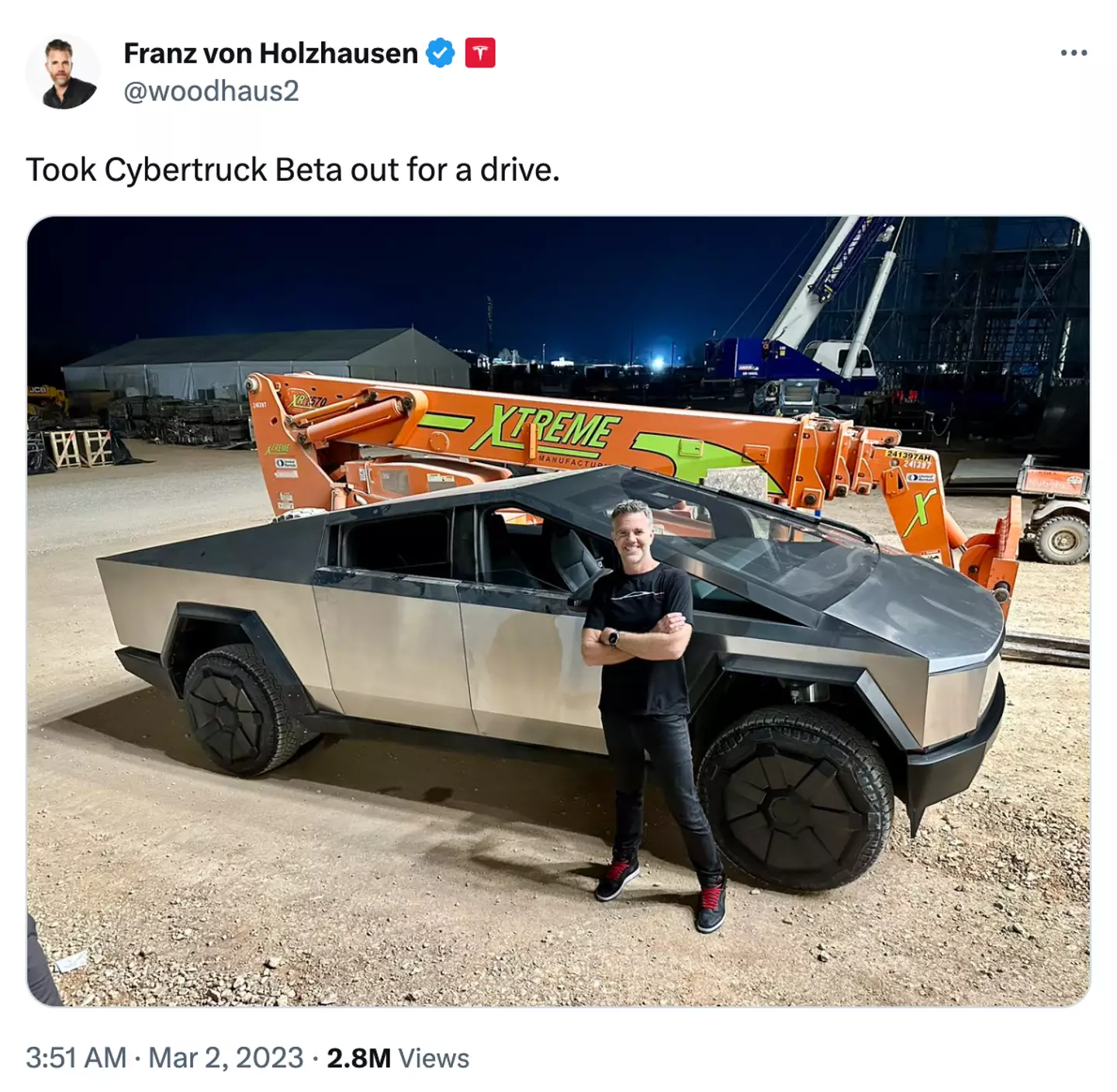Tesla's design chief Franz von Holzhause posing with a rather dusty looking Cybertruck.