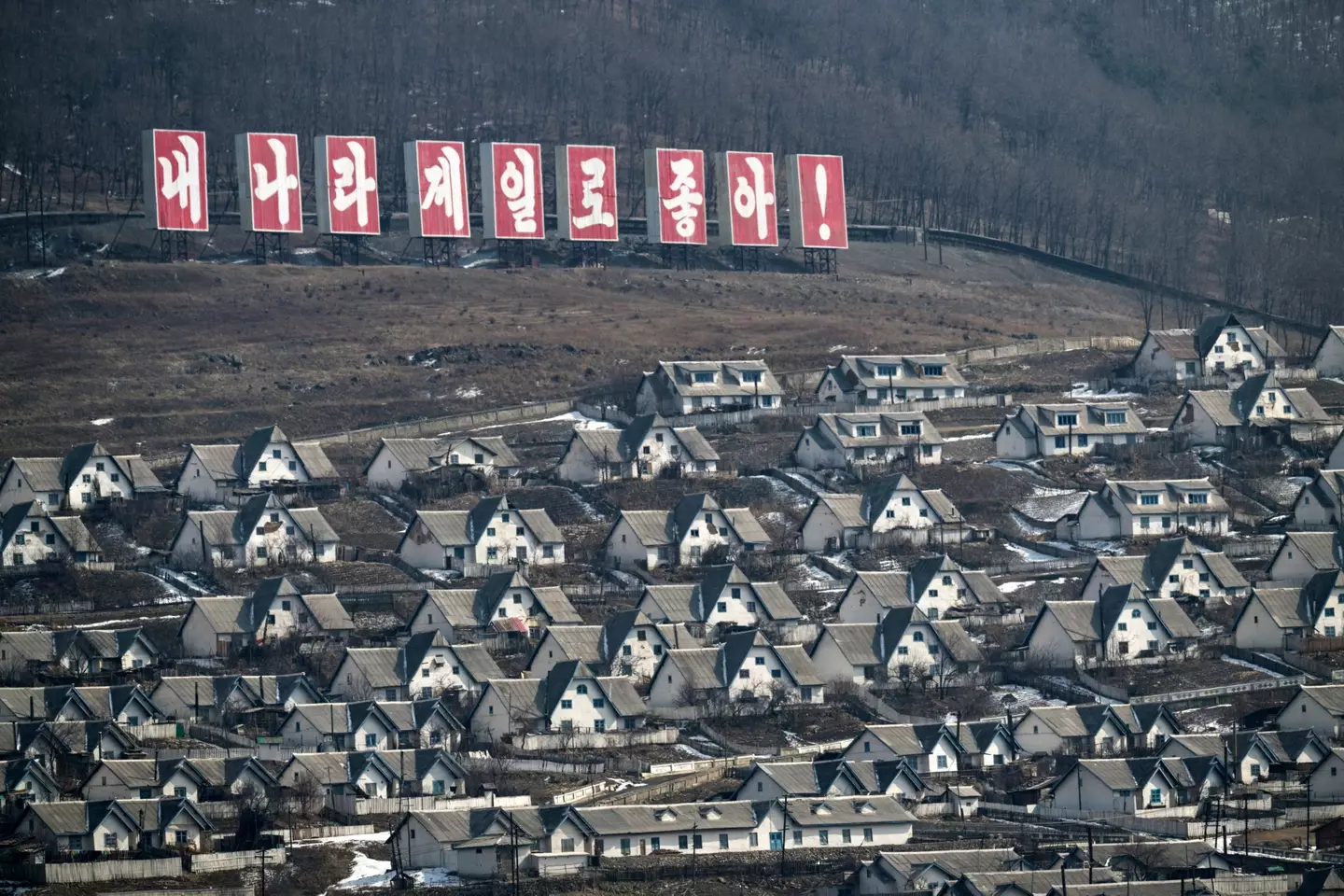The North Korean town of Chunggang with a sign reading 'My country is the best'.