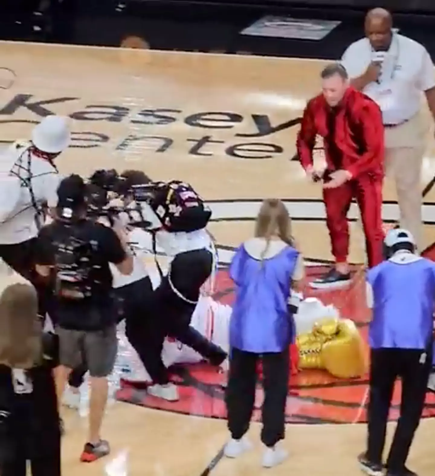 Staff at the game had to drag the mascot off the court.