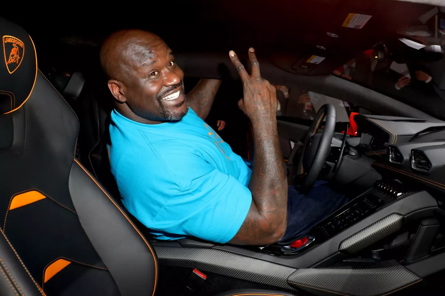 Shaq O'Neal has to go to extreme lengths to fit into a Lamborghini.