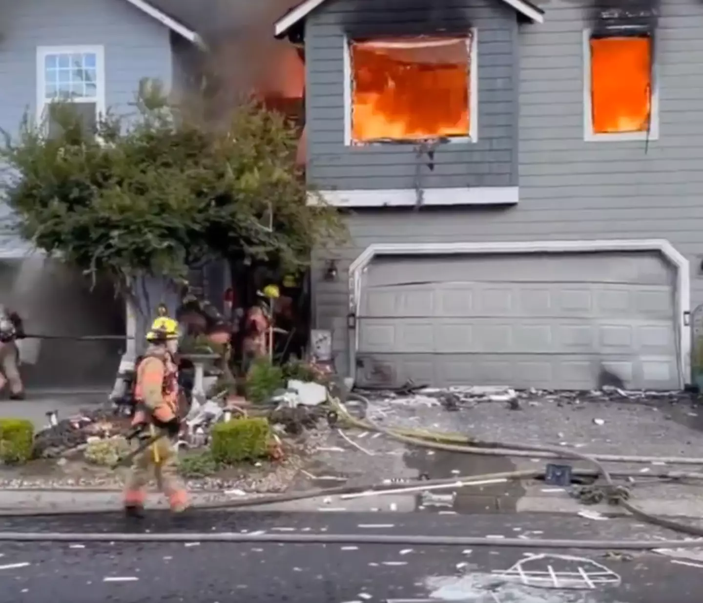 Firefighters attend to the blaze in a property affected by the crash (John Sampson / Facebook)