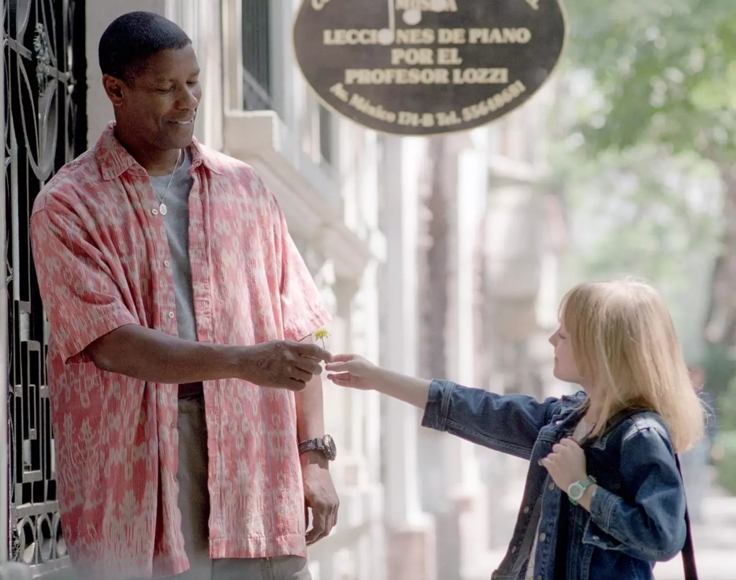 Denzel Washington stars alongside Dakota Fanning in the film.