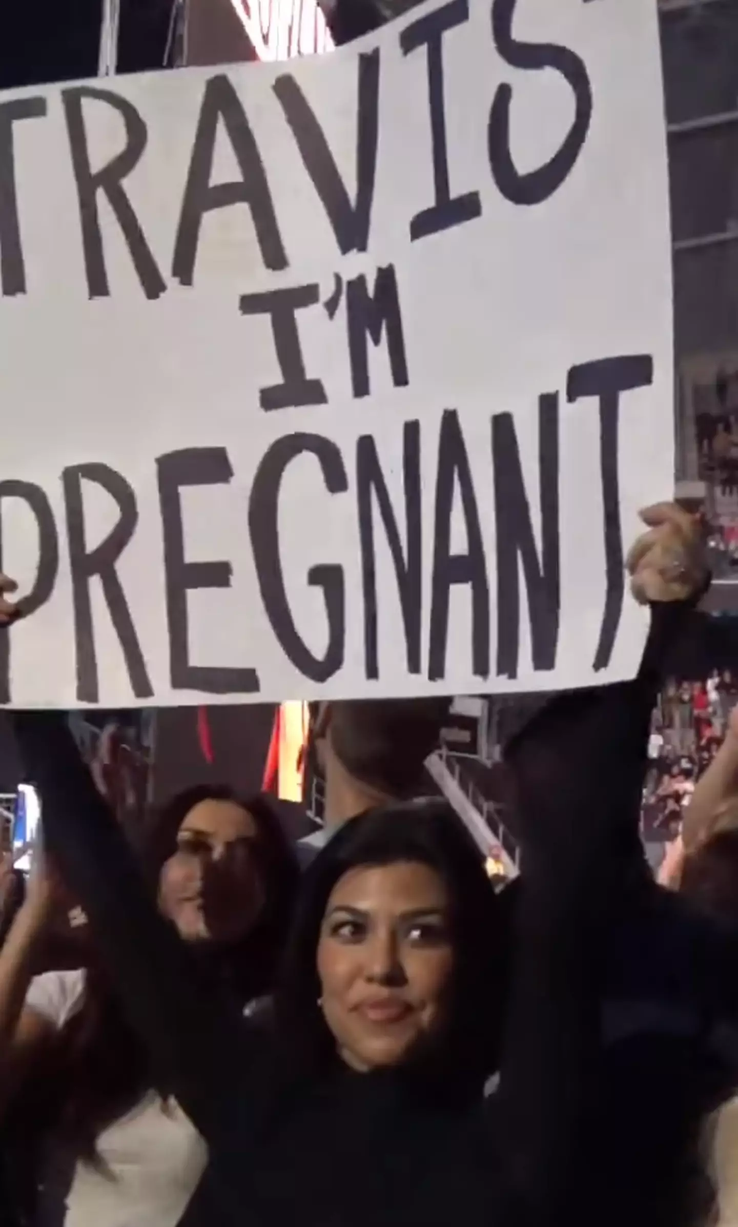 Kourtney held up a sign declaring the news.