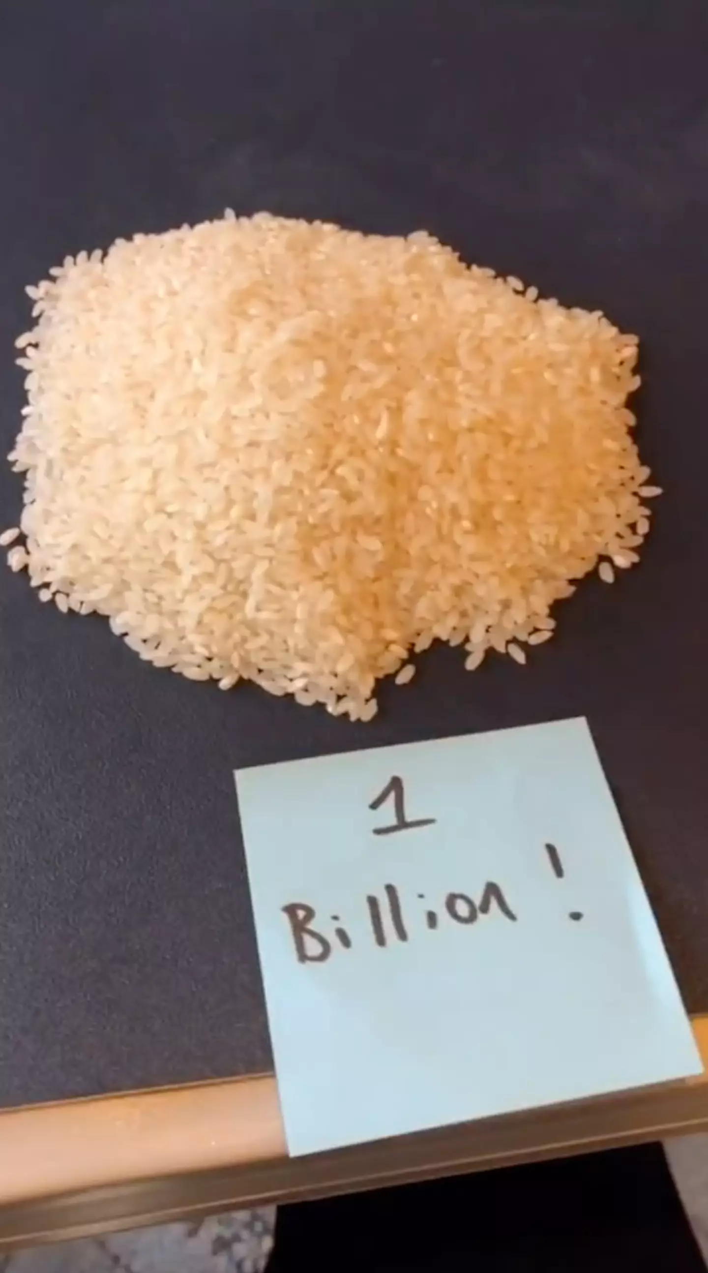 Yang uses the grains to help us visualise just how much money it is.