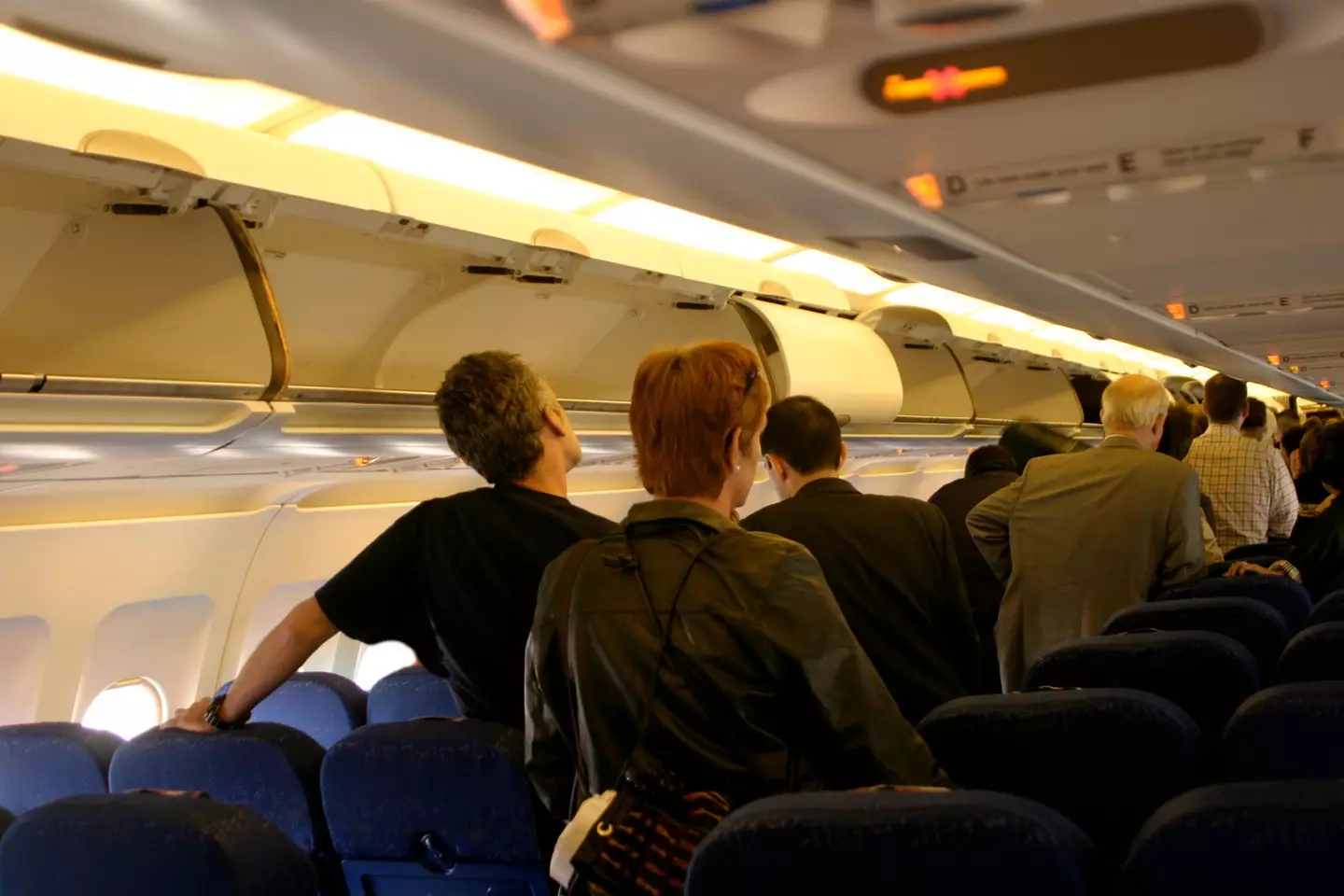 Passengers were furious after being held up by an entitled mom who believed everyone should stand aside to allow her daughter to exit from the back of the plane with her (Getty stock)