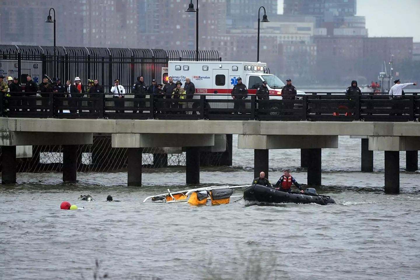 Police and firefighters work on the site after a helicopter crashed into the Hudson River near lower Manhattan, on April 10 (Lokman Vural Elibol/Anadolu via Getty Images)
