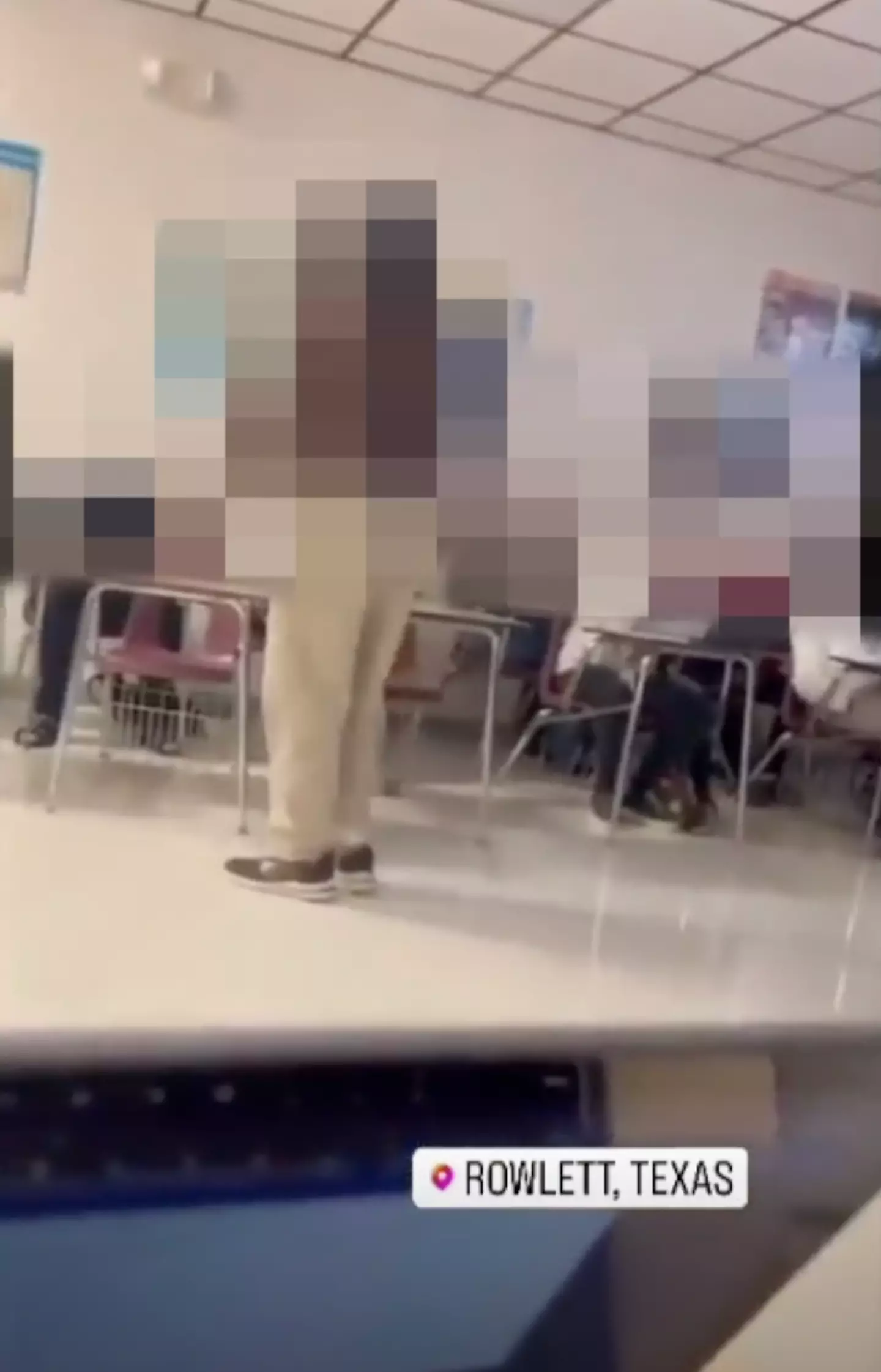 In the video, the teacher can be seen throwing a chair.