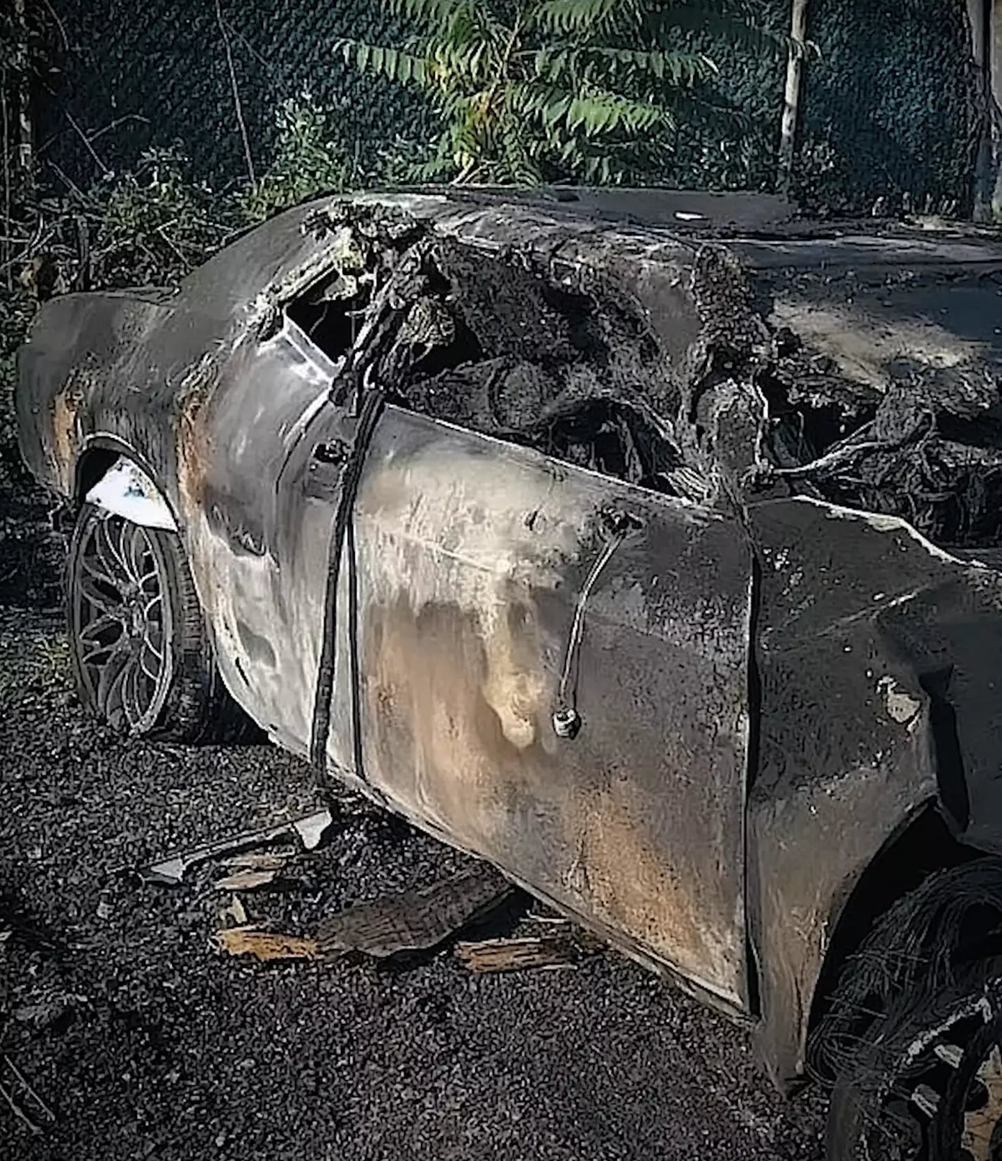 The teen's burned Dodge Challenger pictured shortly after the accident took place (Joe DiMeo)